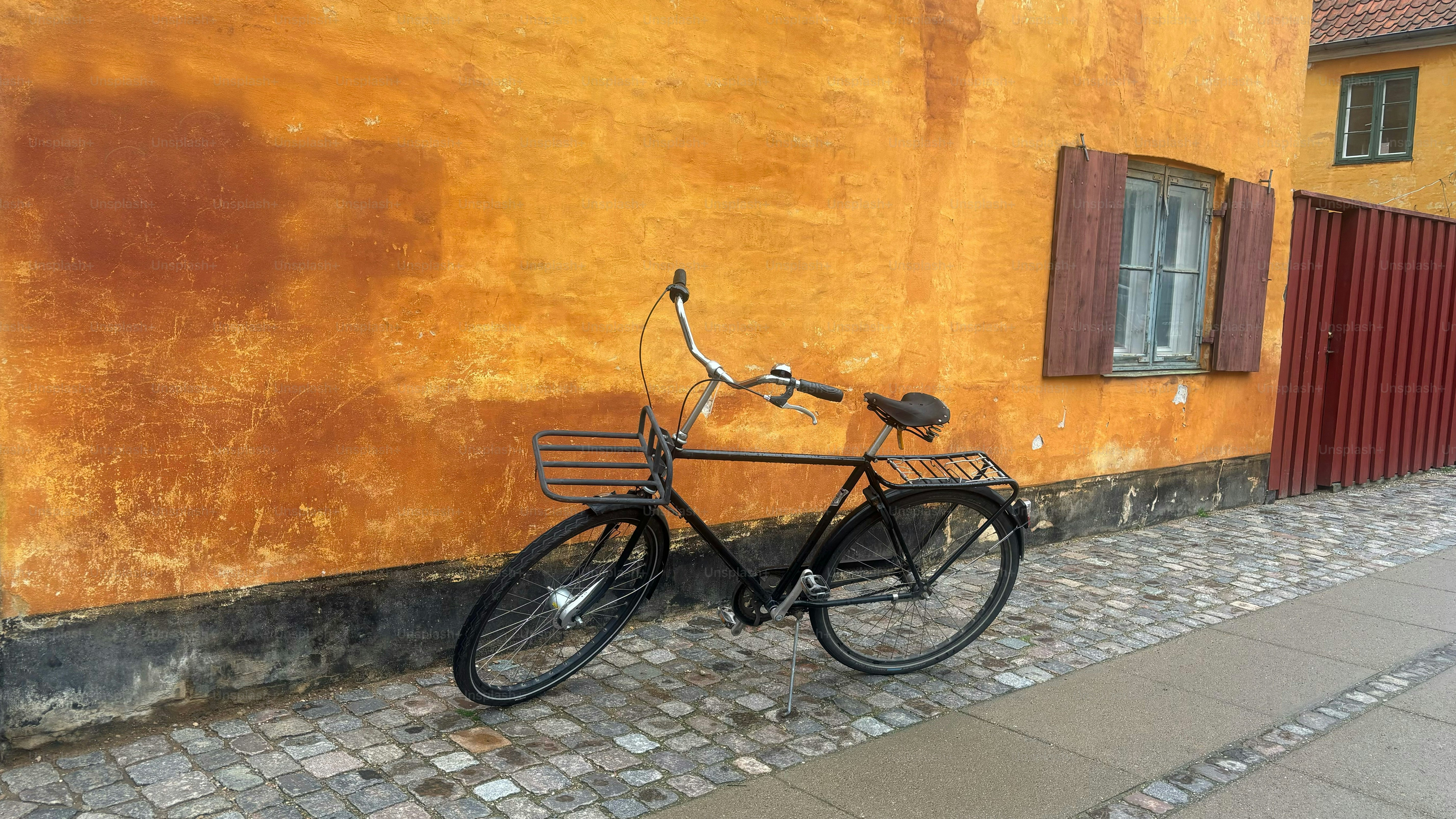 Bicycle on a street  Leaning against a Yellow Building