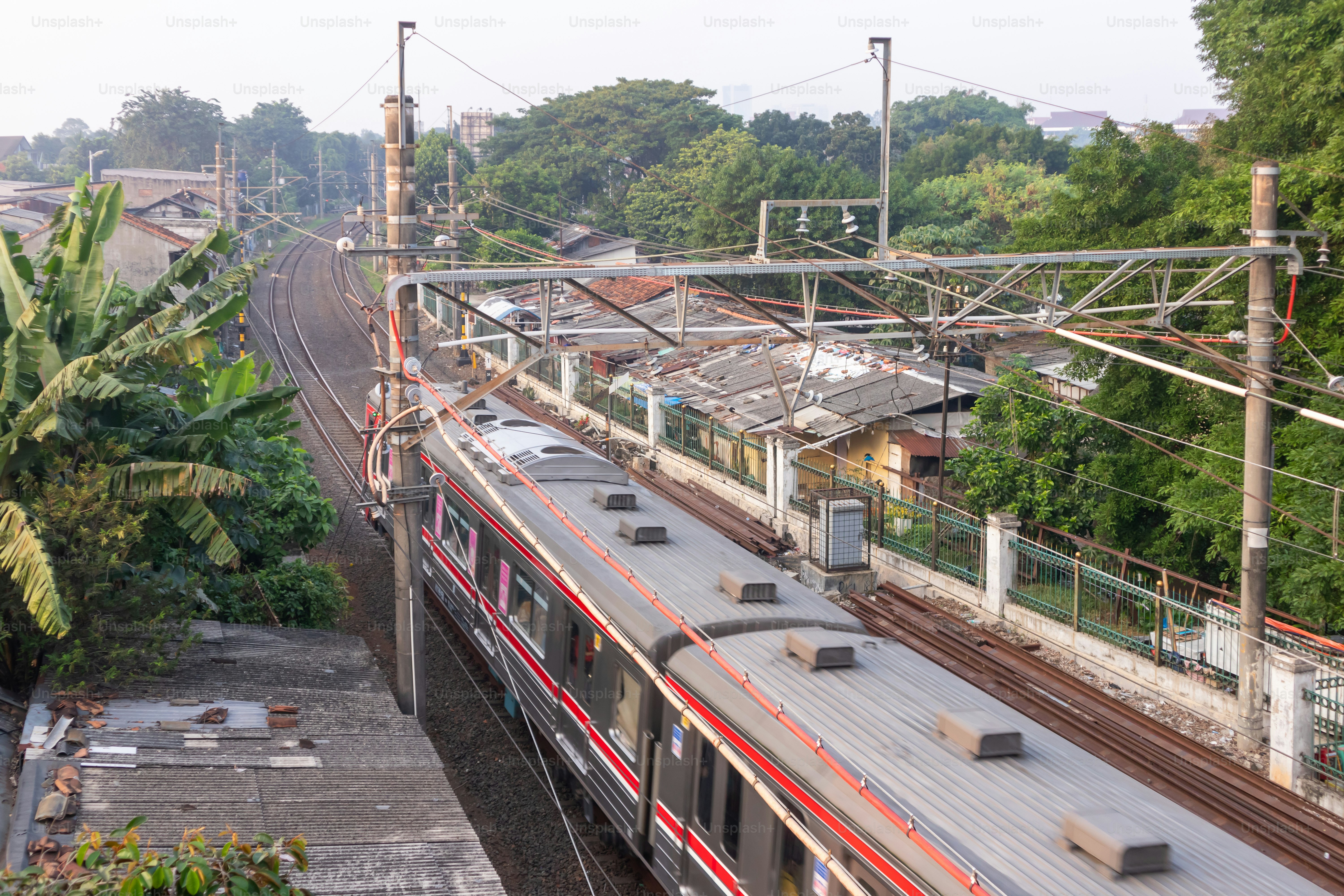 Jakarta, Indonesia - May 09, 2024: View of the commuter train passes through residential areas in South Jakarta.