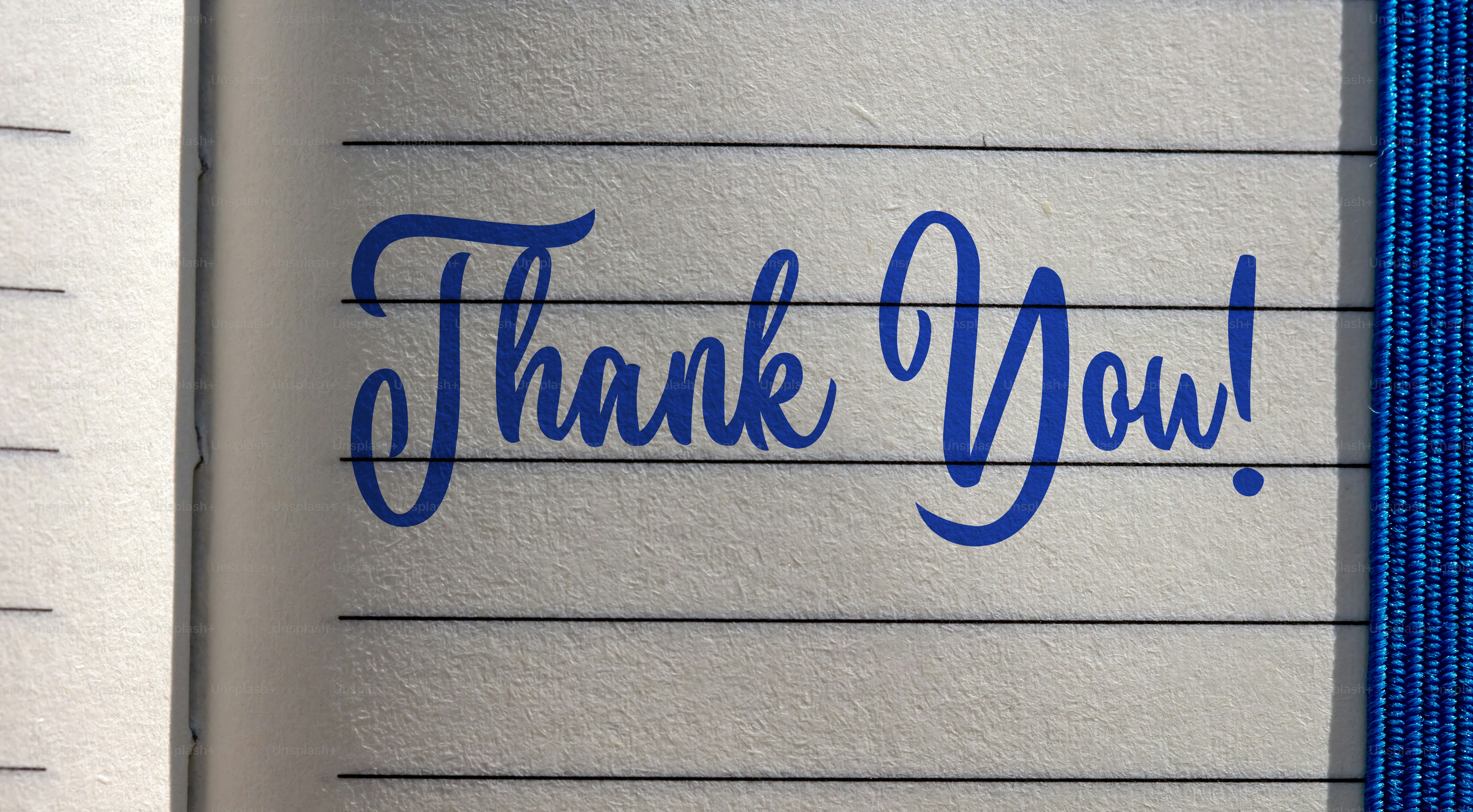 THANK YOU! lettering on a notebook page with a blue bookmark.