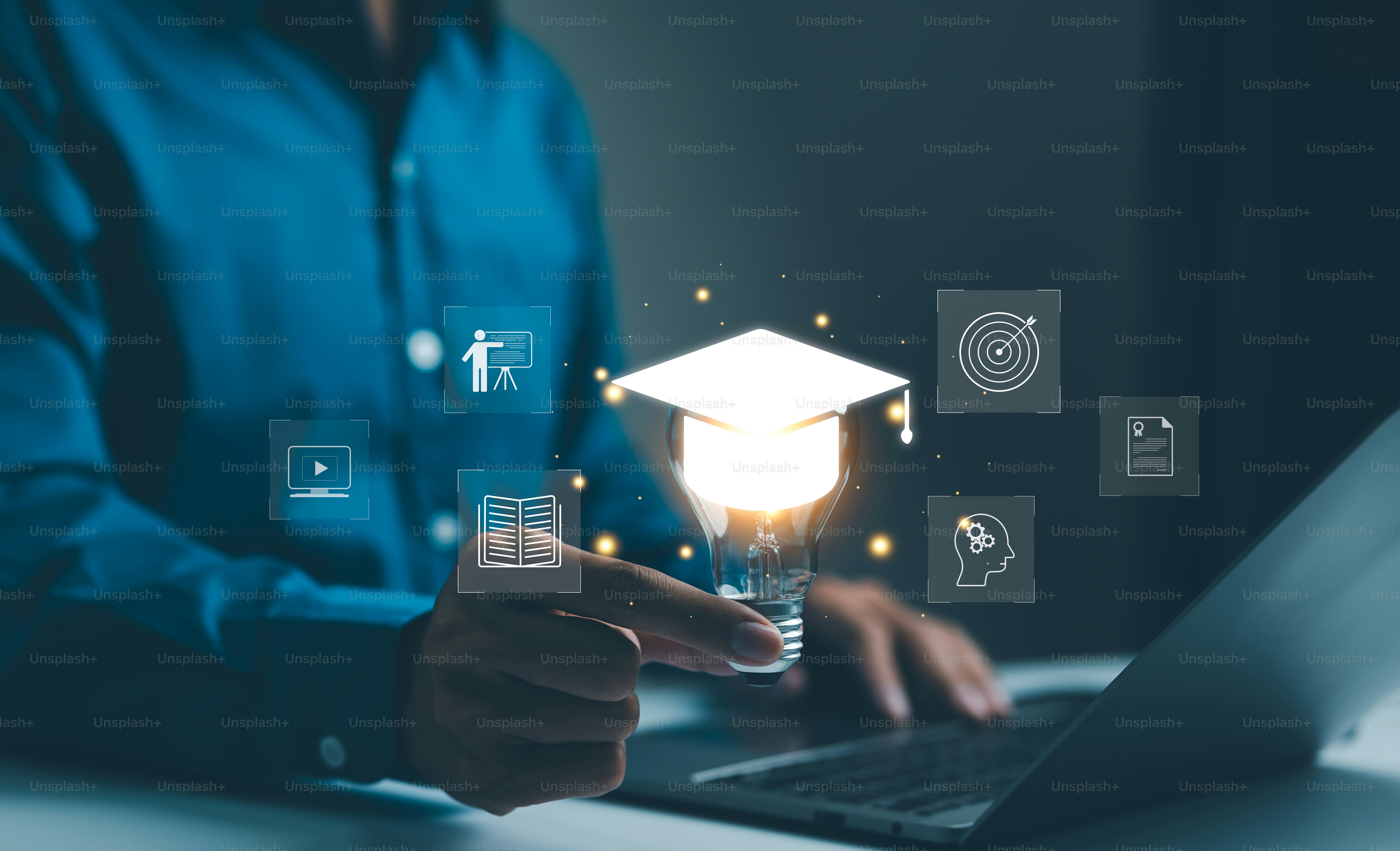 A person holding a glowing light bulb with a graduation cap icon
