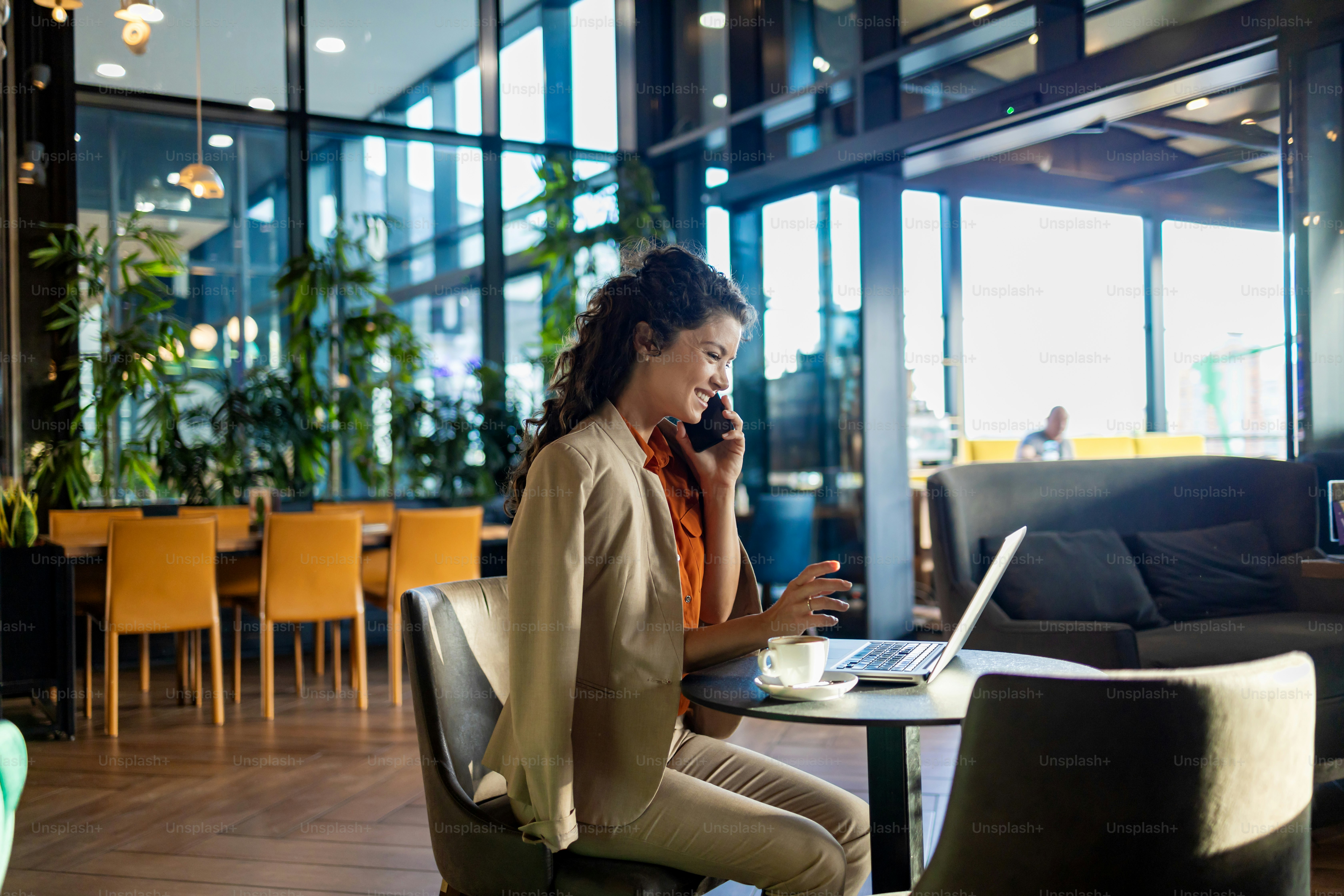 Backpacker using phone and laptop for travel banking security in a café