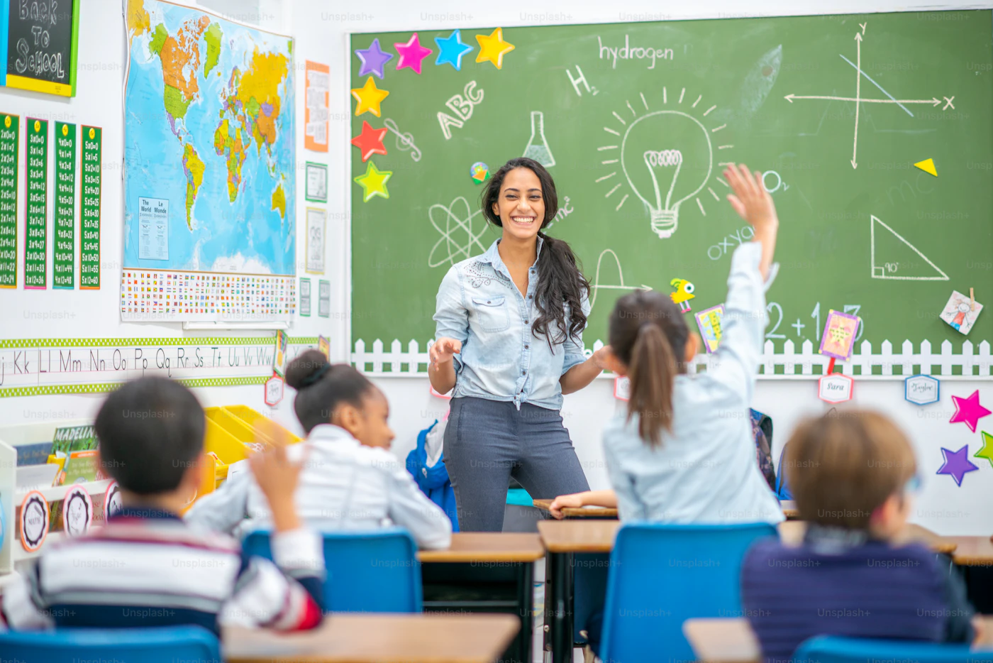 A teacher and students in a bright classroom