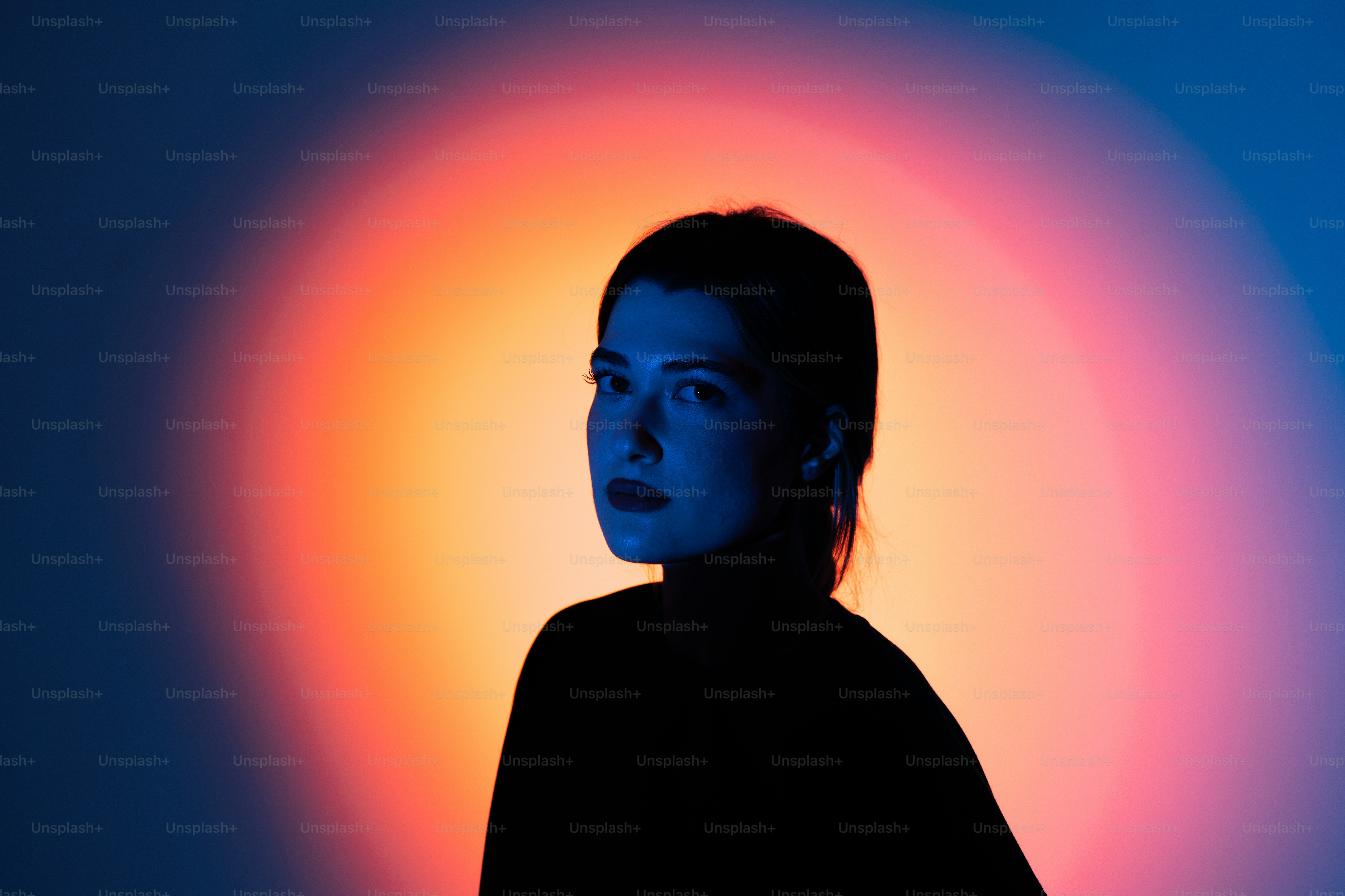 A woman standing in front of a colorful background