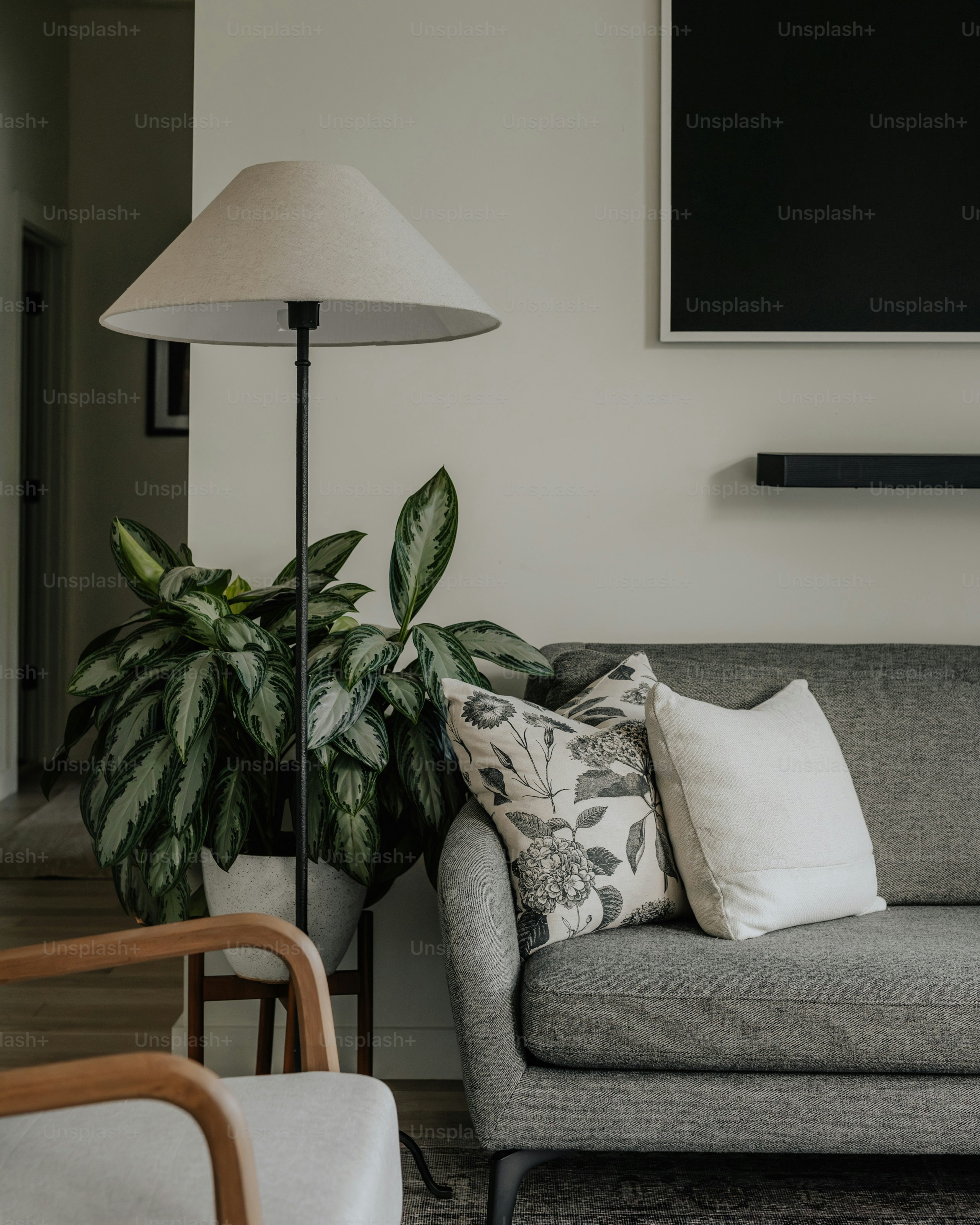 A living room with a couch, chair, lamp and television