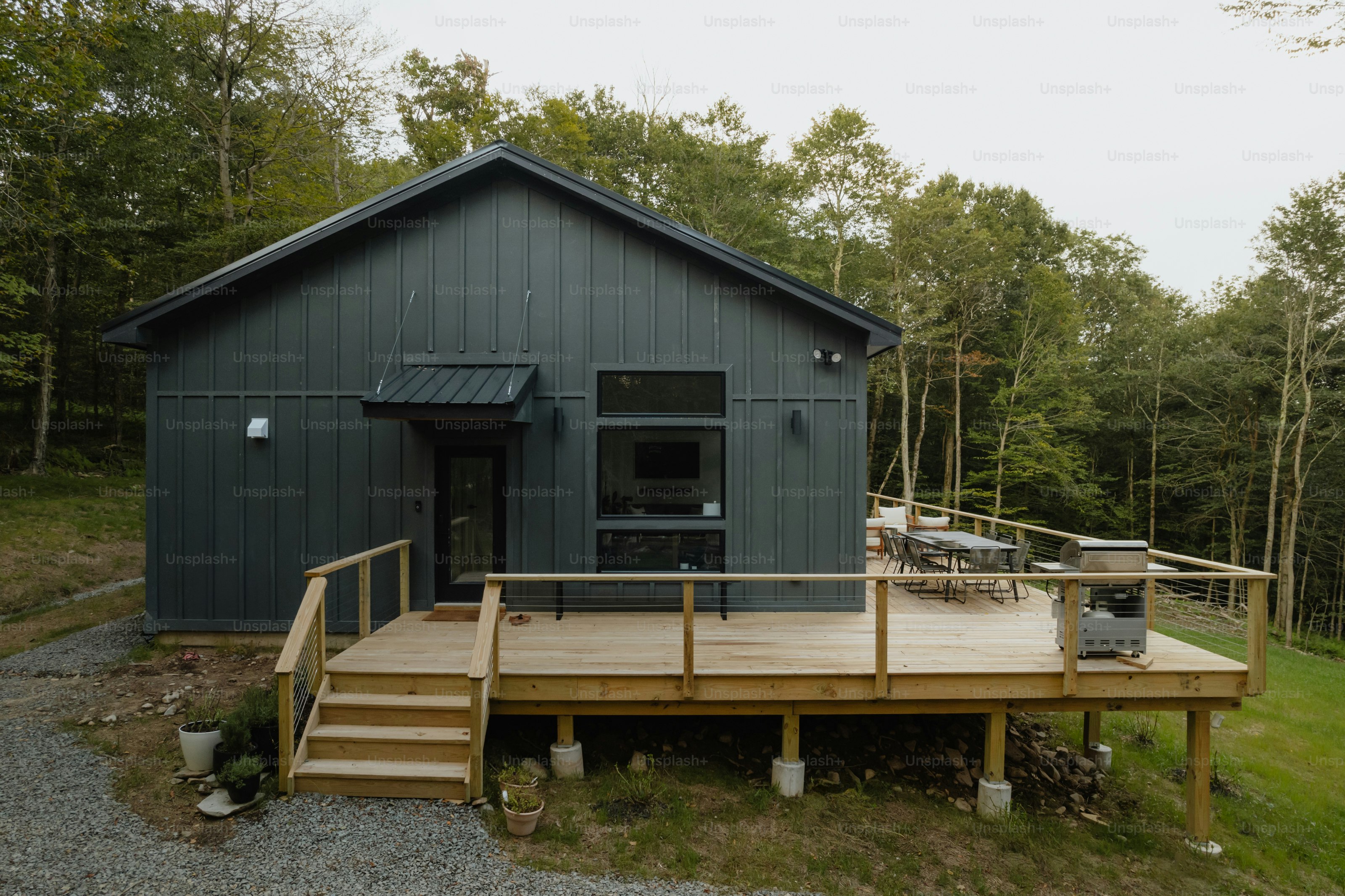 A small cabin in the woods with a deck