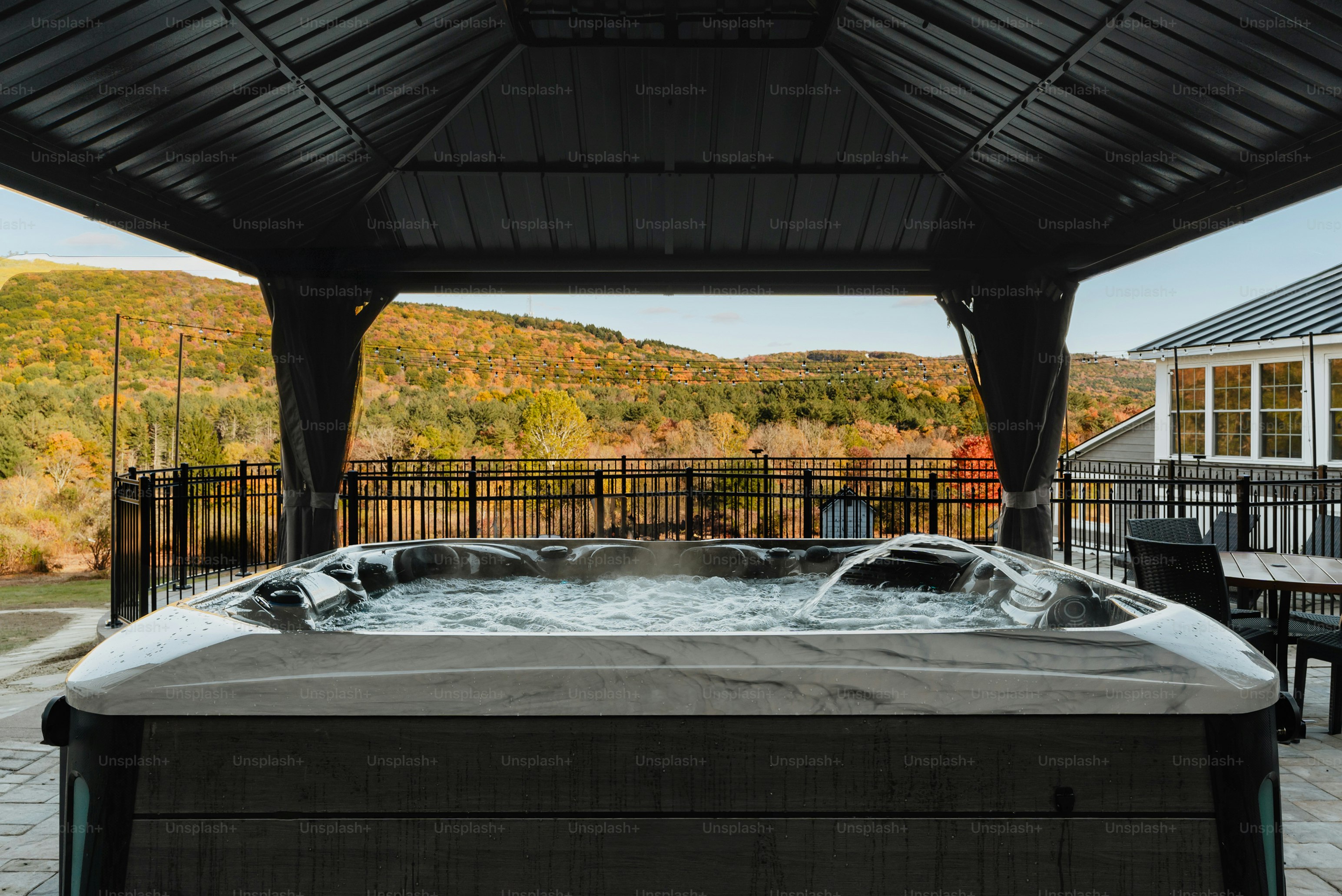 A hot tub sitting under a covered patio
