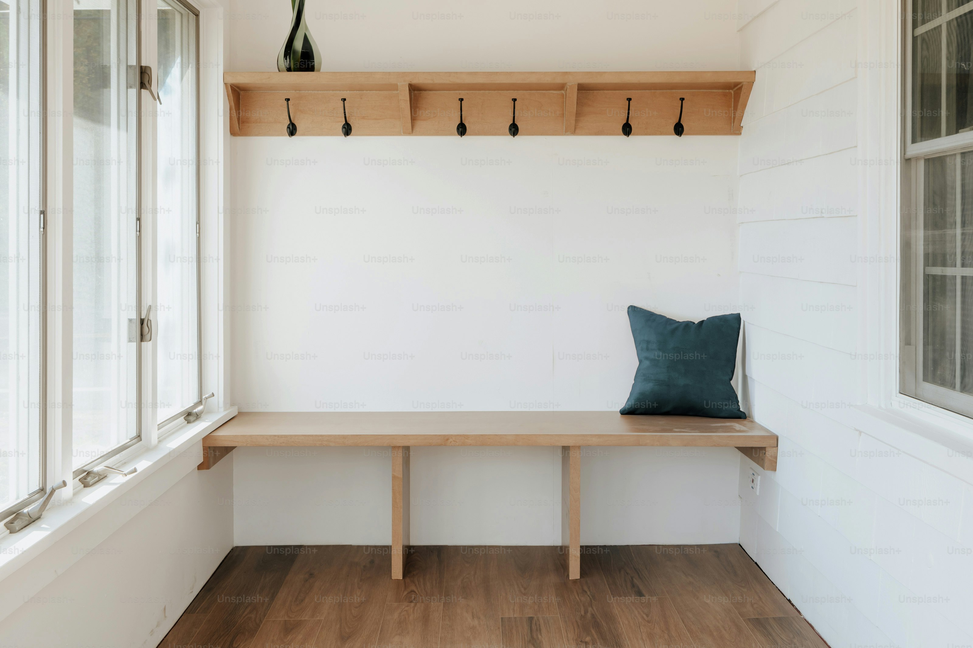 Family organizing entryway storage with bench, baskets, and shoe rack in a functional mudroom.