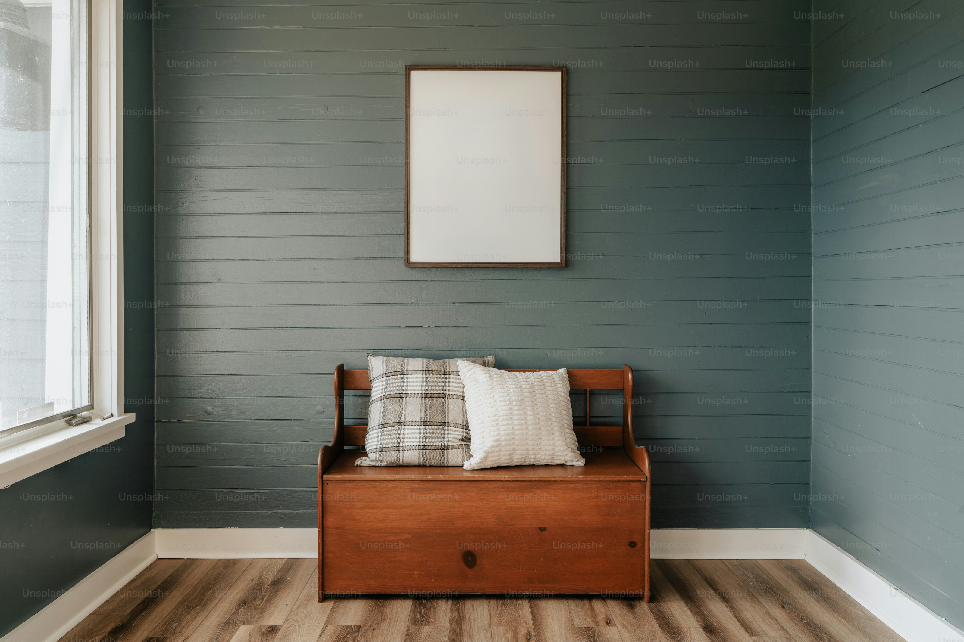 A room with a chair and a picture frame on the wall