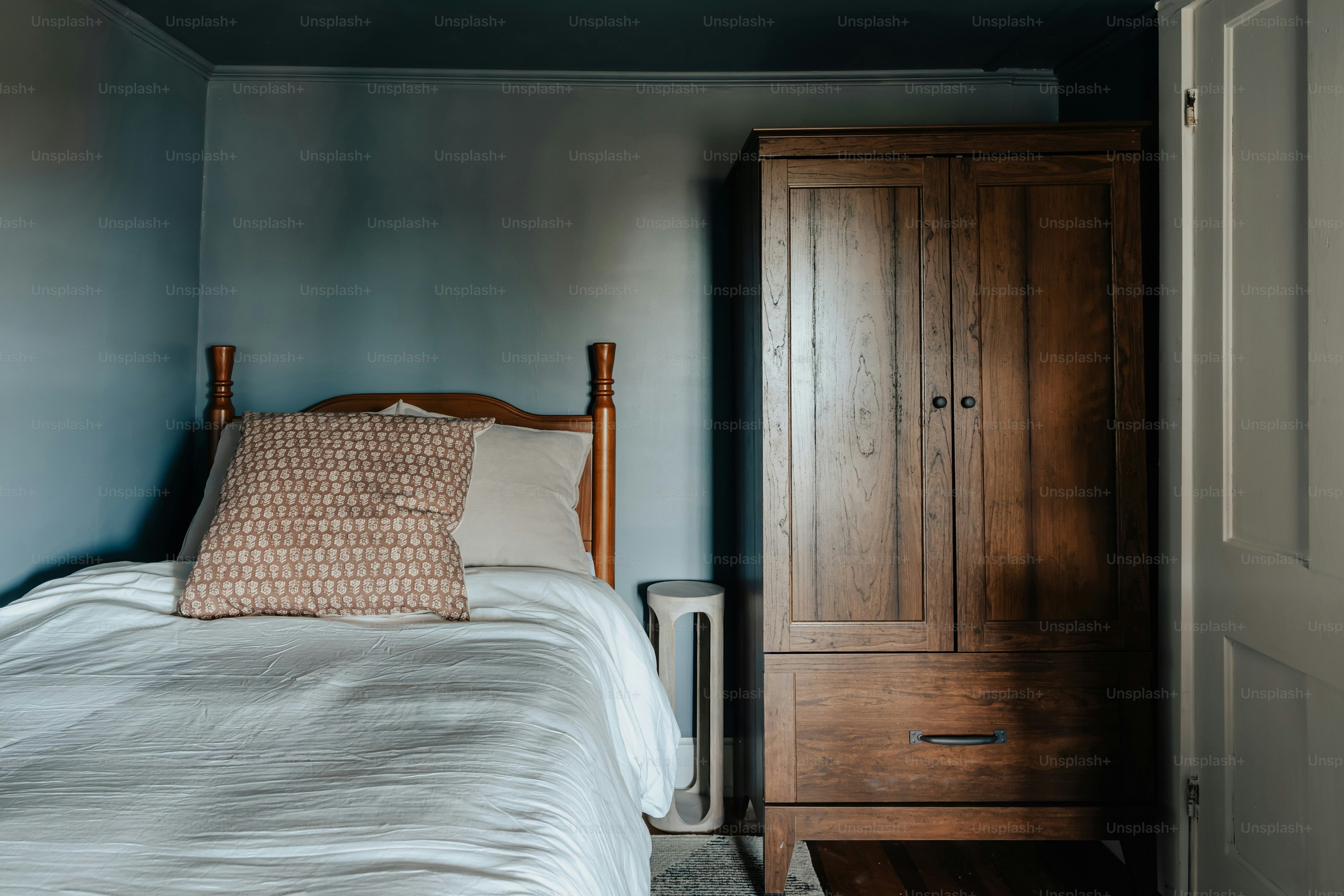 A bed sitting in a bedroom next to a closet