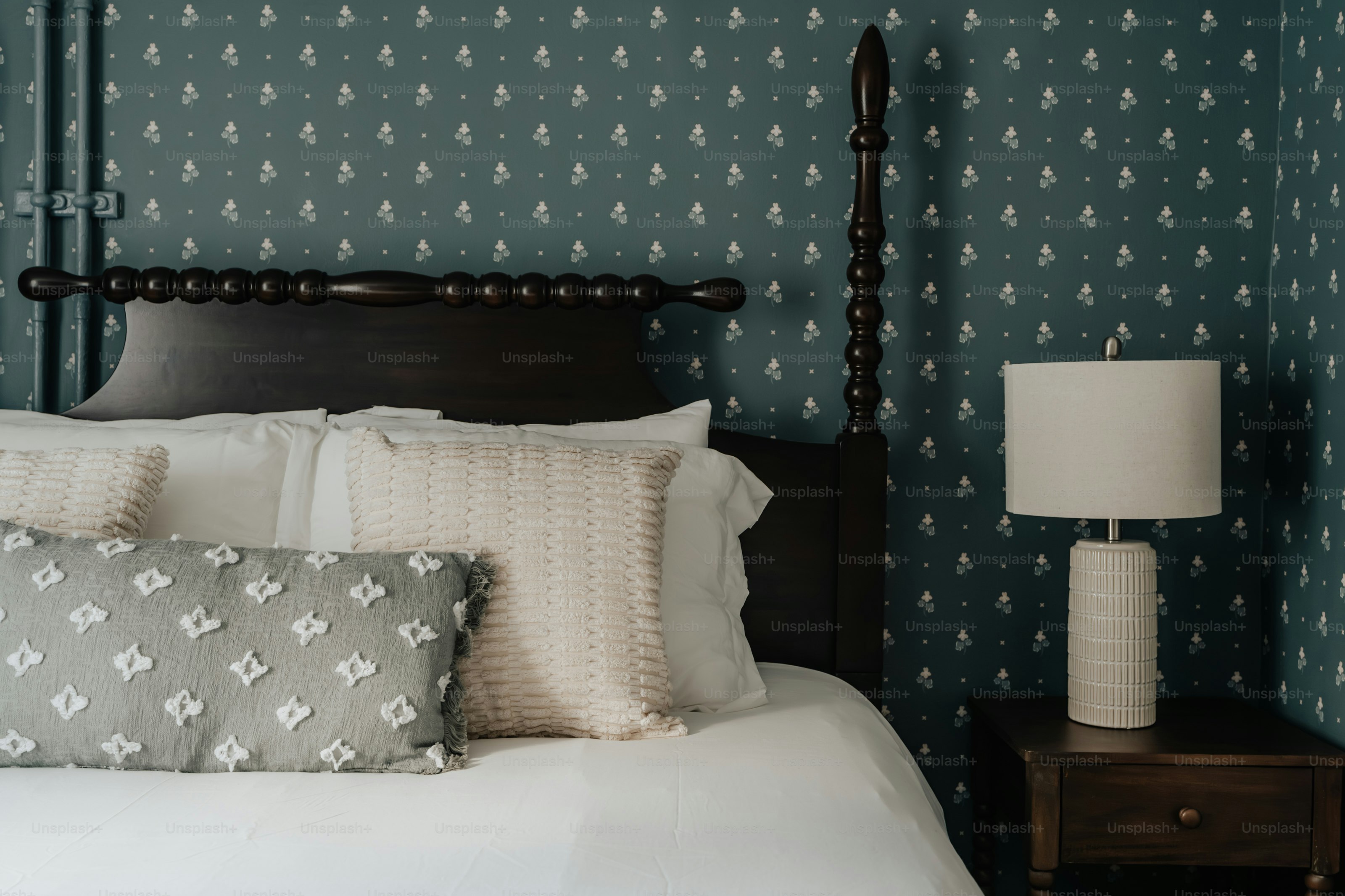 A bedroom with a bed and a night stand photo – Wallpaper Image on Unsplash
