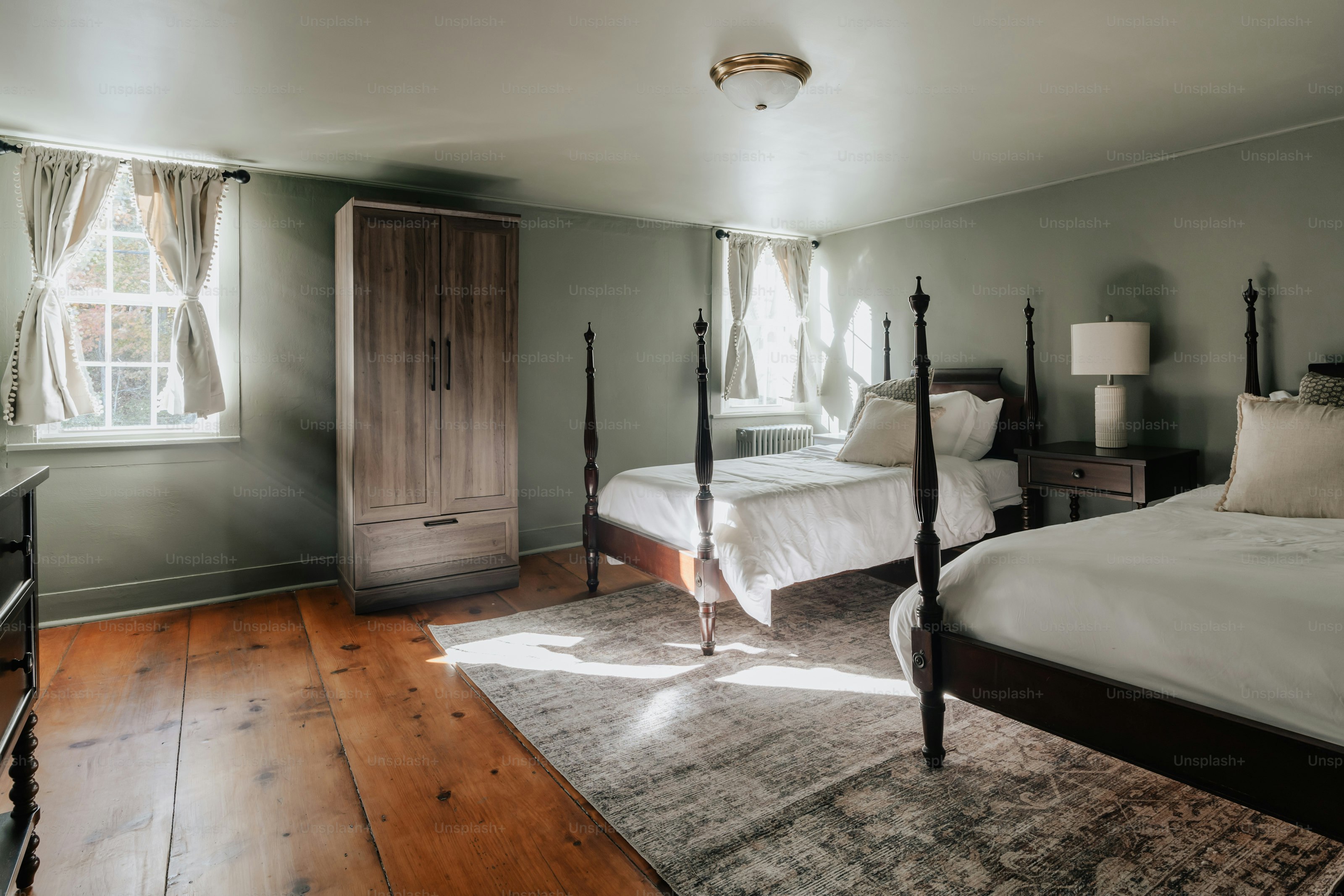 A bedroom with two beds and a dresser