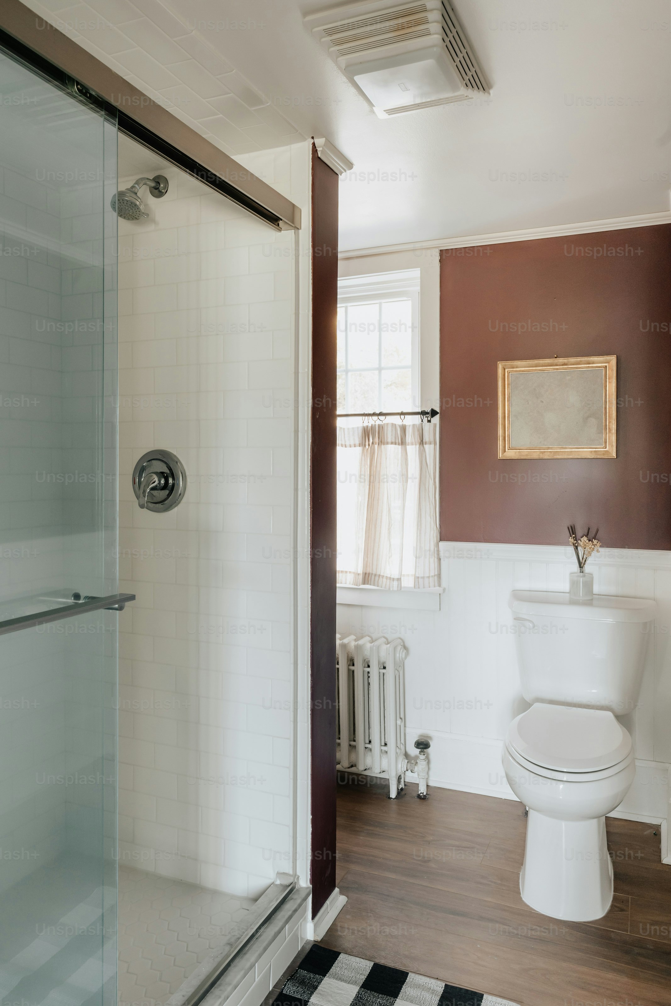 A white toilet sitting next to a walk in shower