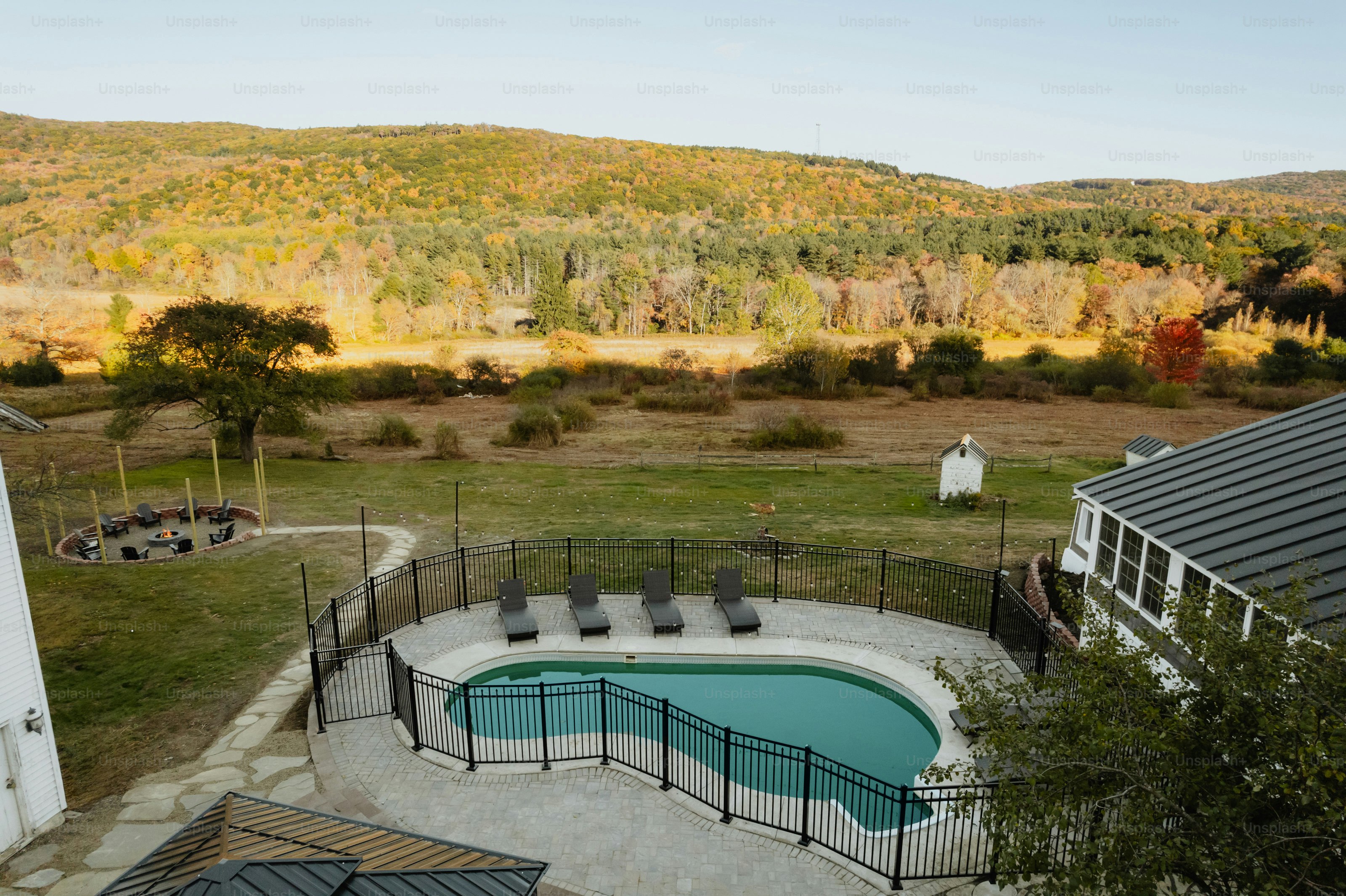 An aerial view of a backyard with a swimming pool