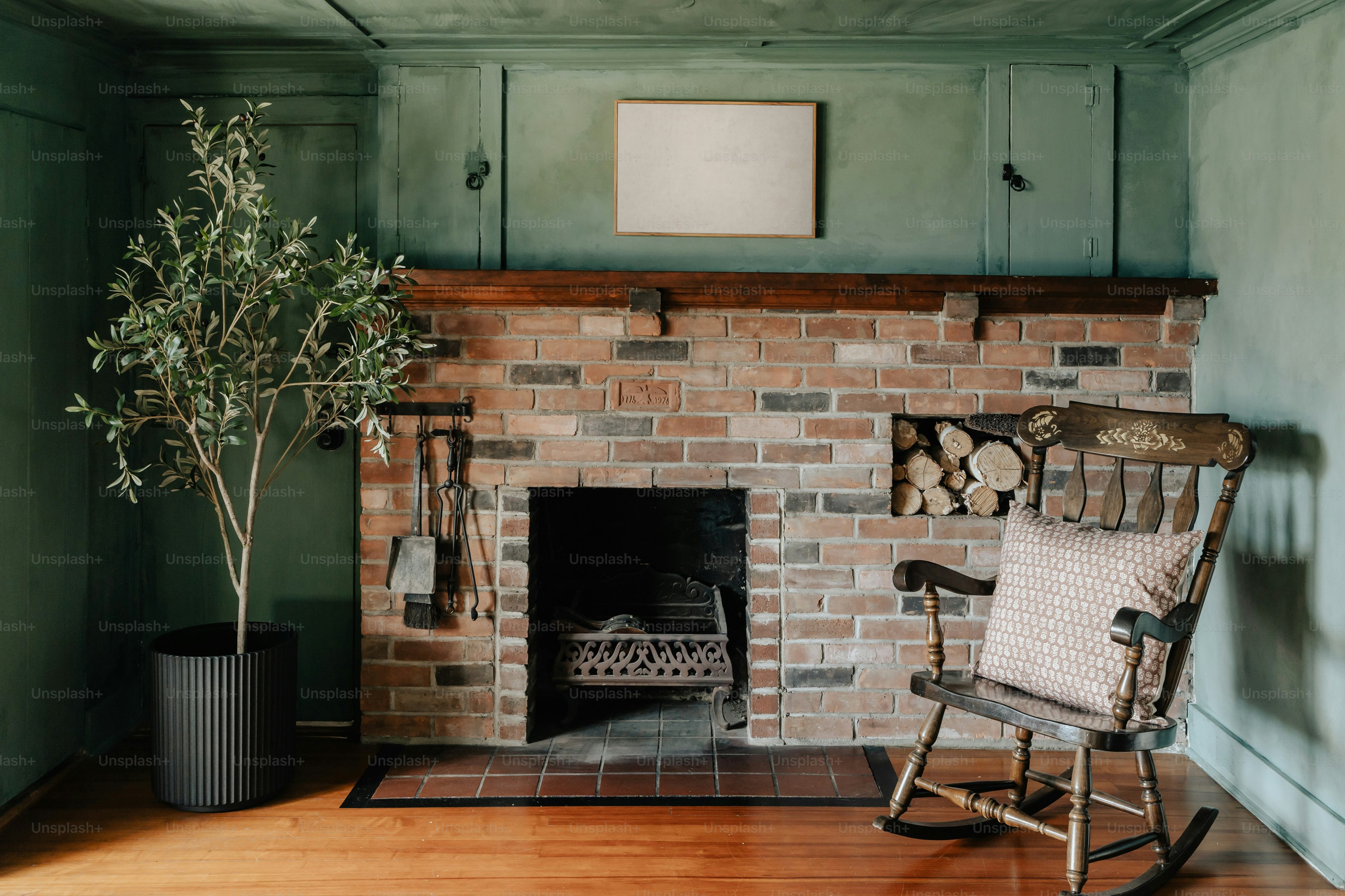 A room with a rocking chair and a fire place