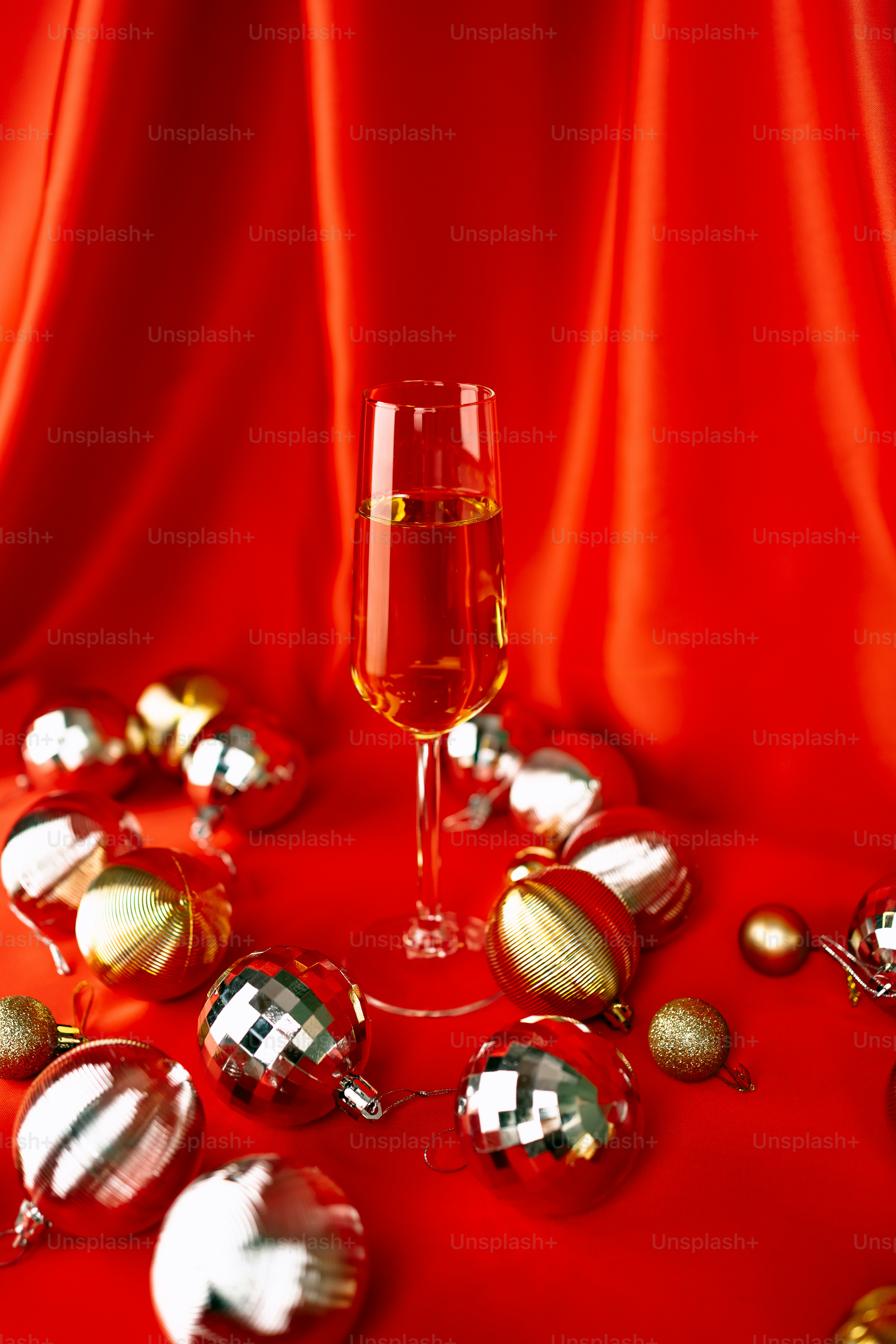 A glass of champagne surrounded by christmas ornaments