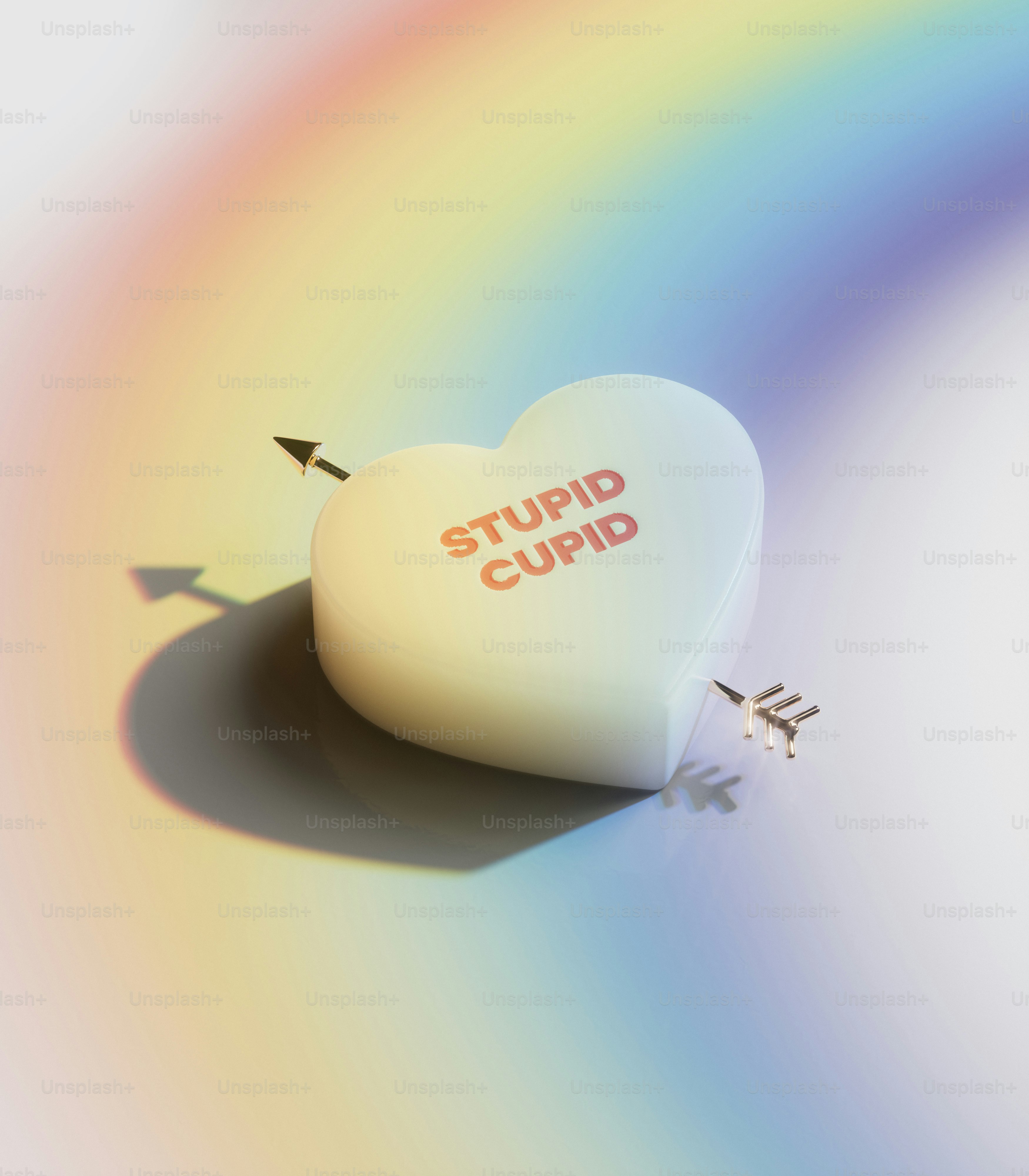 A heart shaped object with a rainbow in the background