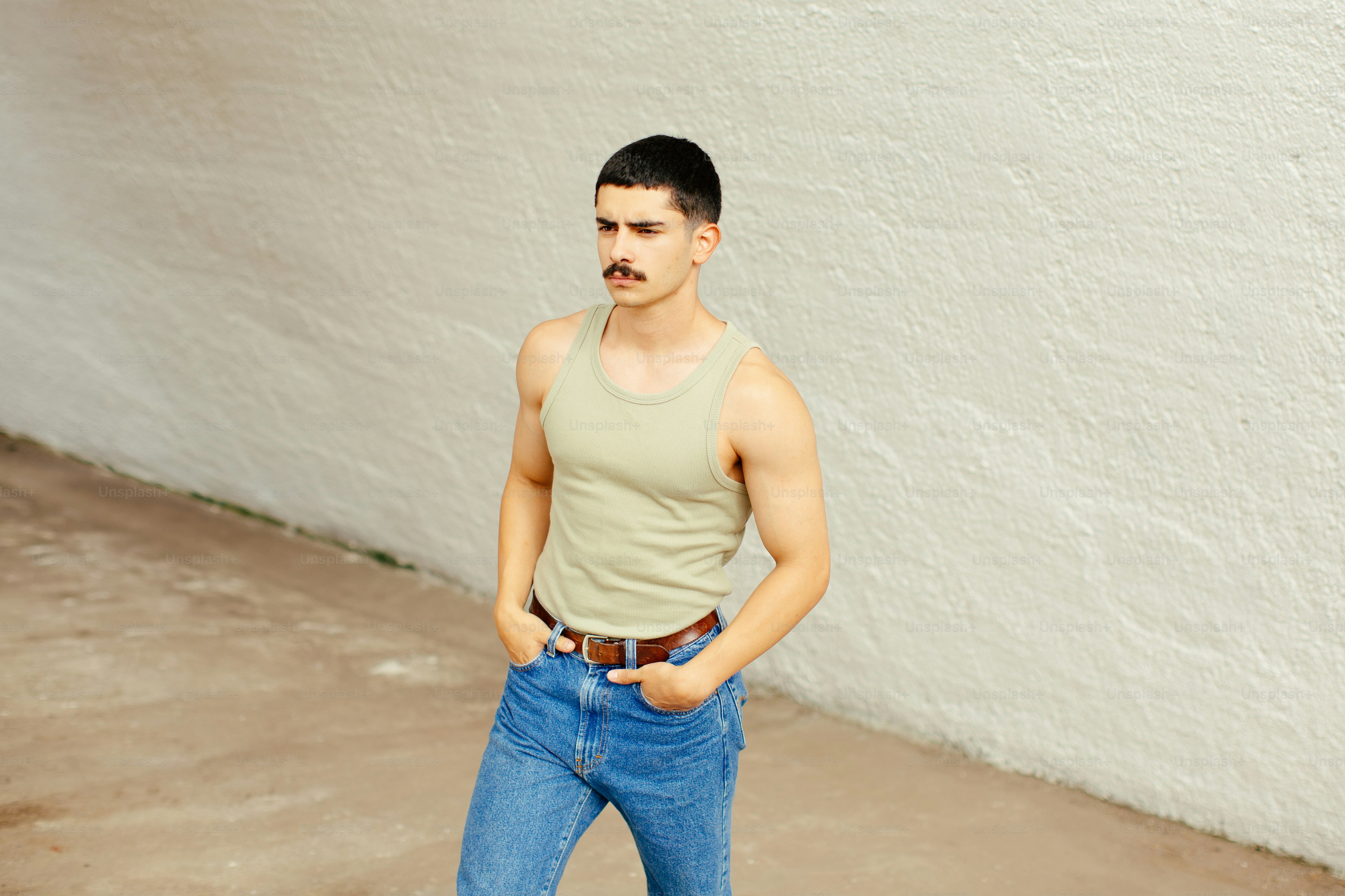 A man standing in front of a white wall photo – Fashion Image on Unsplash