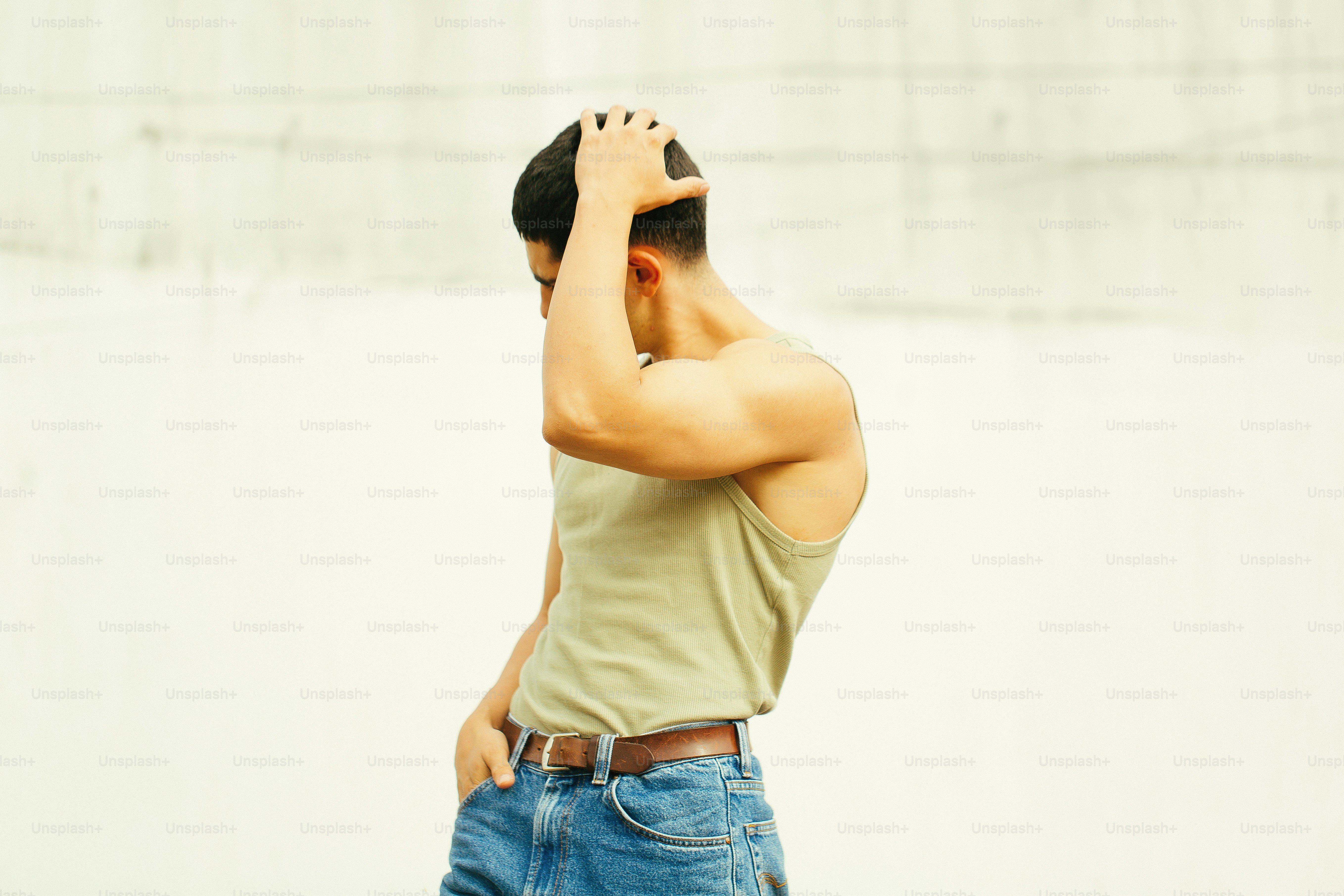 A man standing in front of a white wall photo – Fashion Image on Unsplash