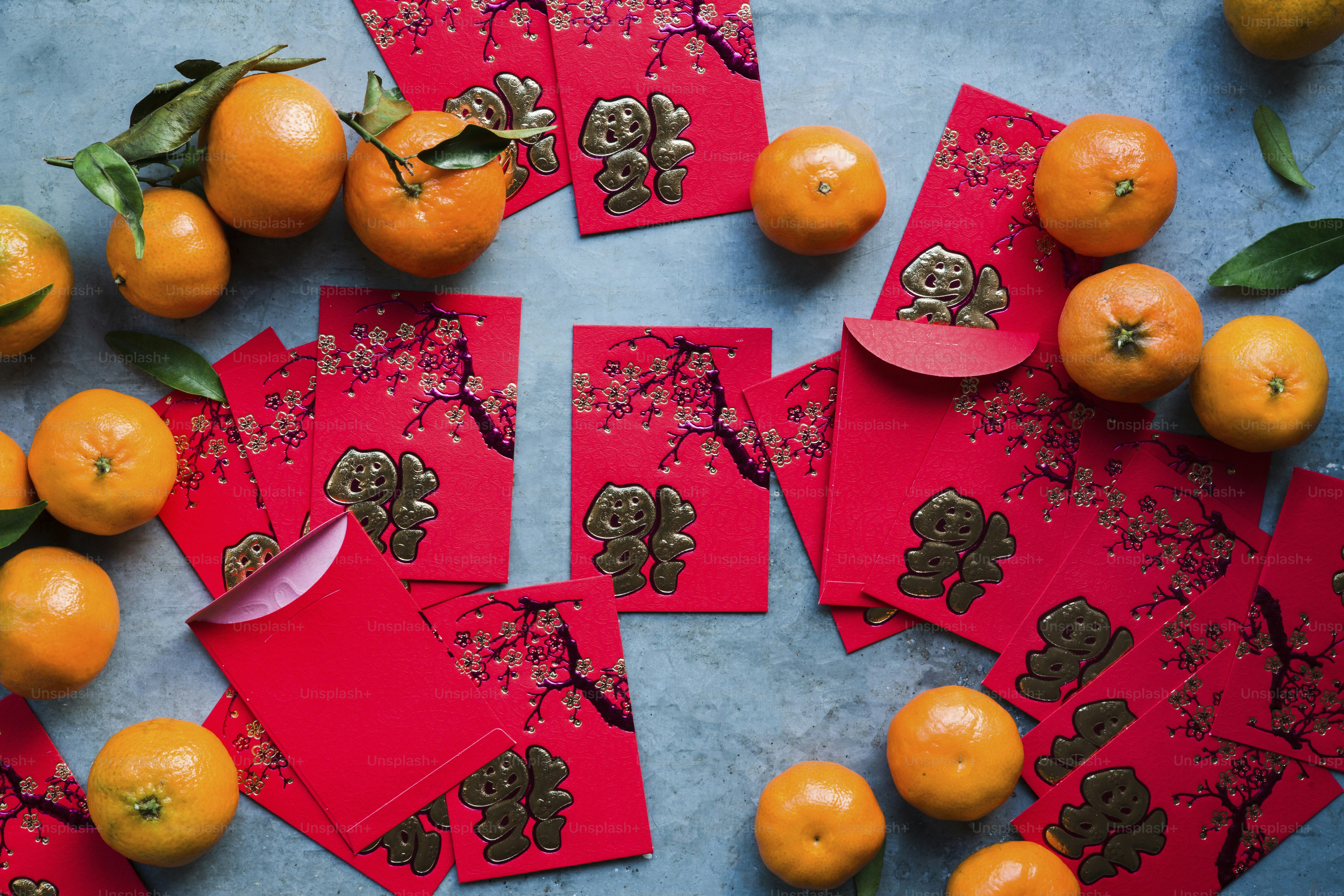 A table topped with lots of oranges and cards