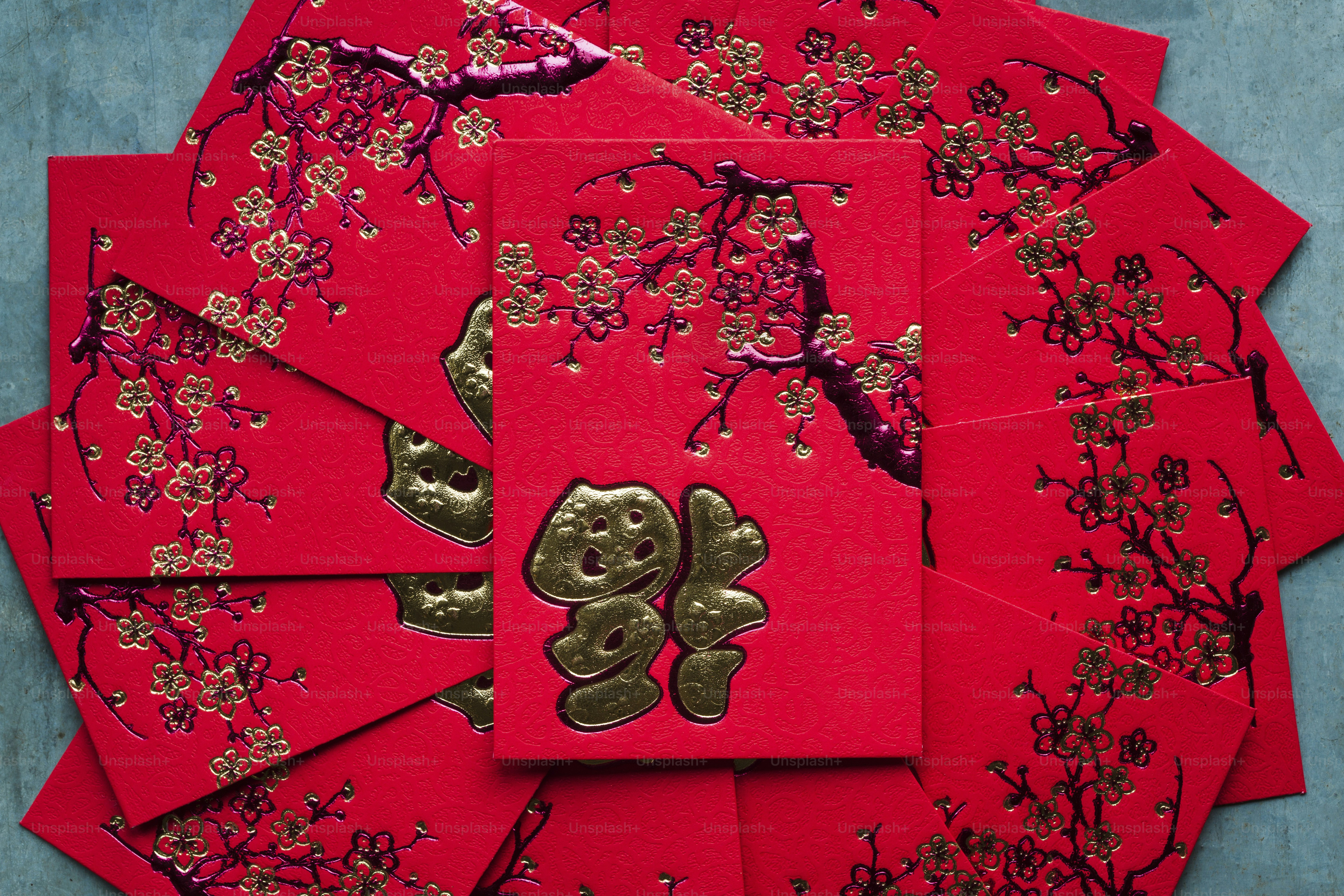 A bunch of red cards with gold foil on them