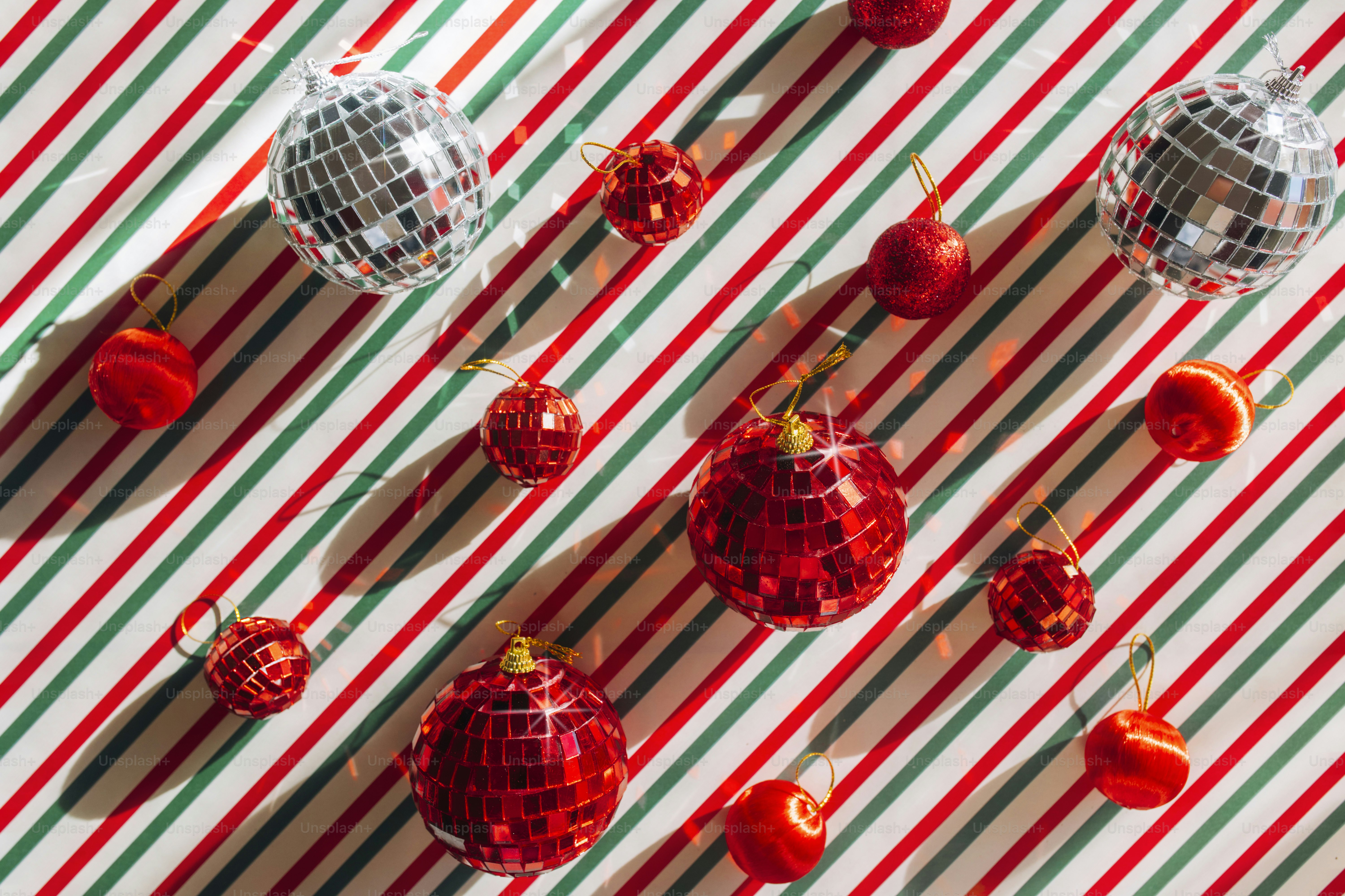 A group of red and white ornaments on a striped table cloth