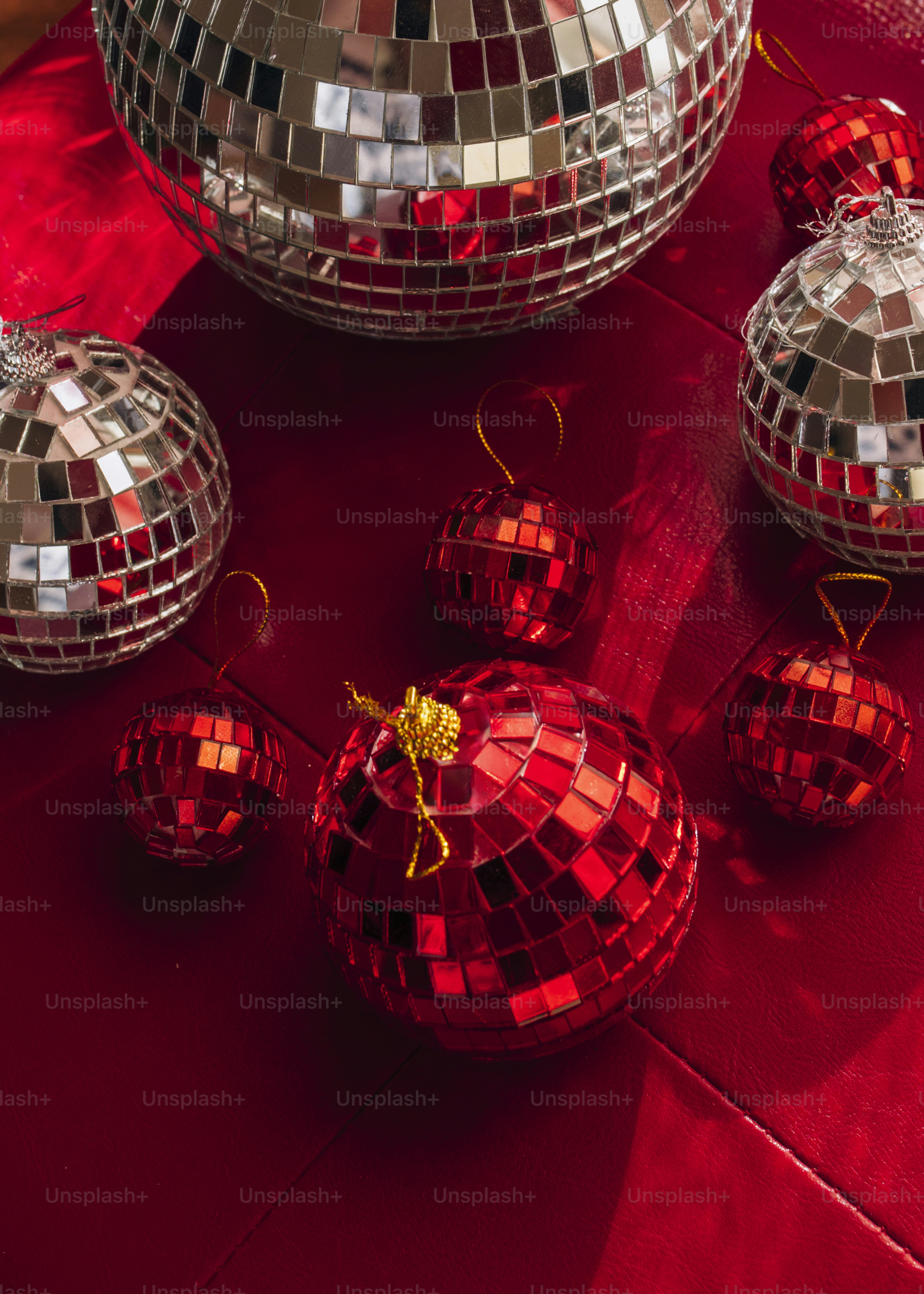 A group of shiny disco balls sitting on top of a red table