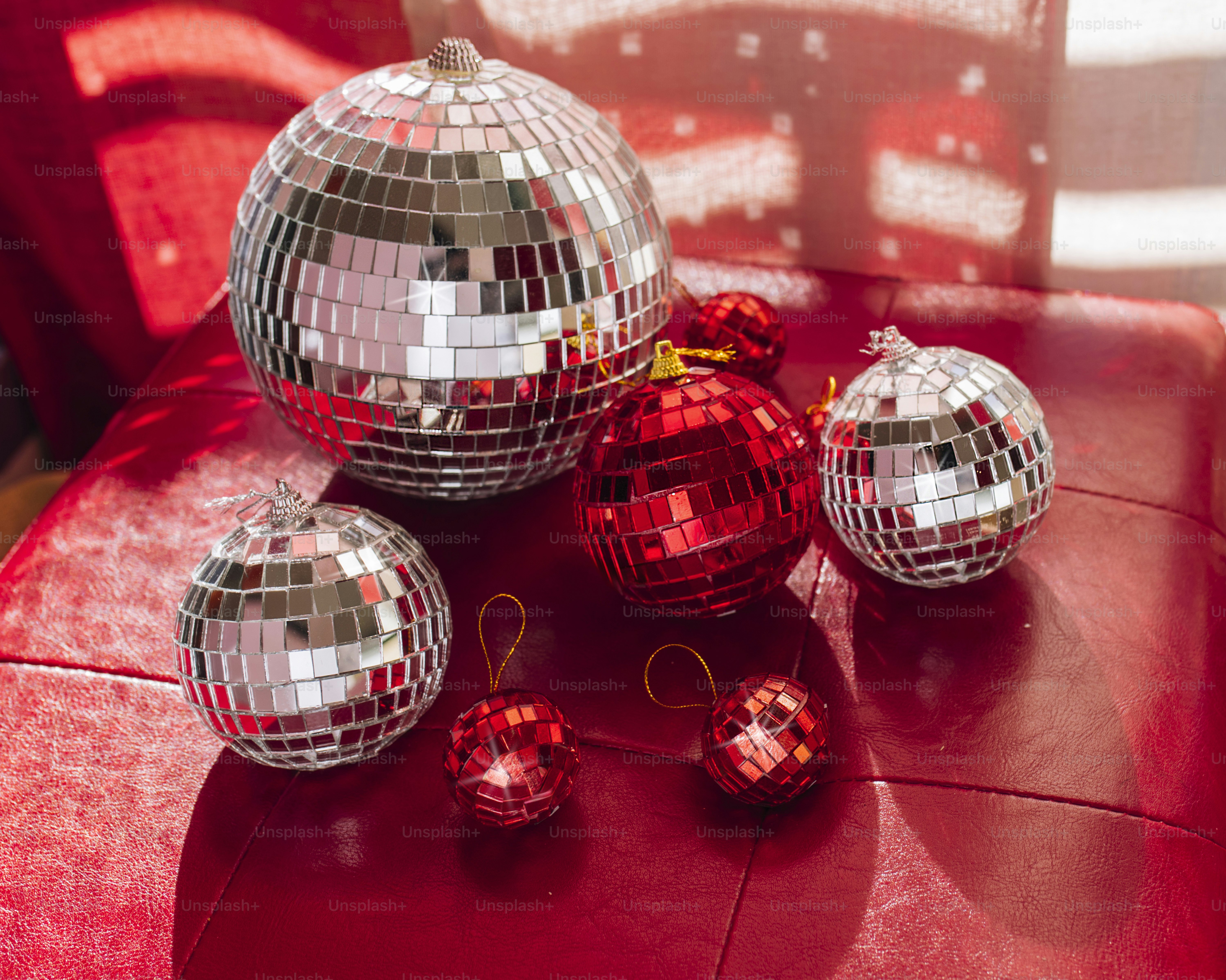 A group of shiny disco balls sitting on top of a red table