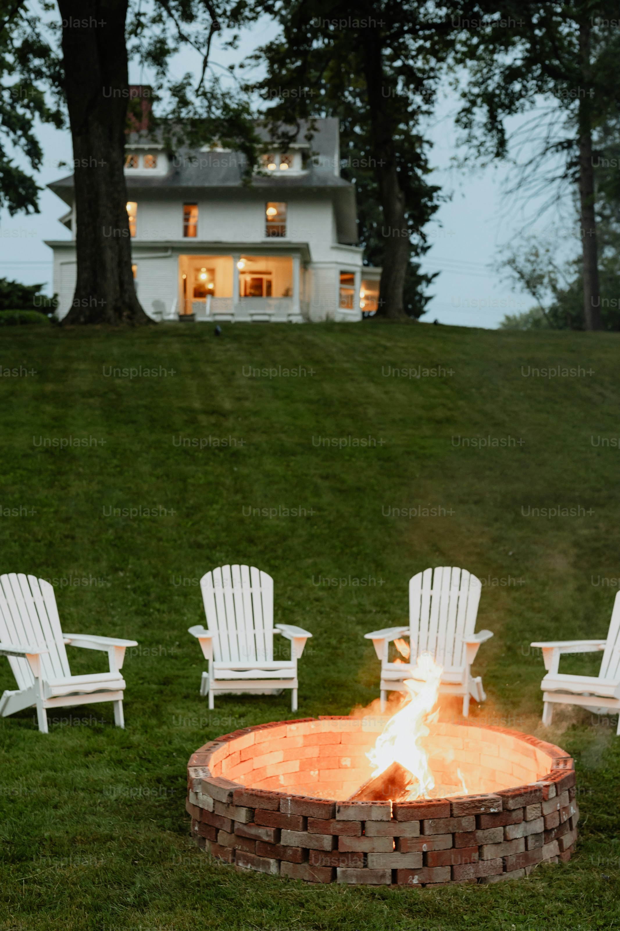 Elegant outdoor fire pits creating a luxury backyard gathering area at dusk