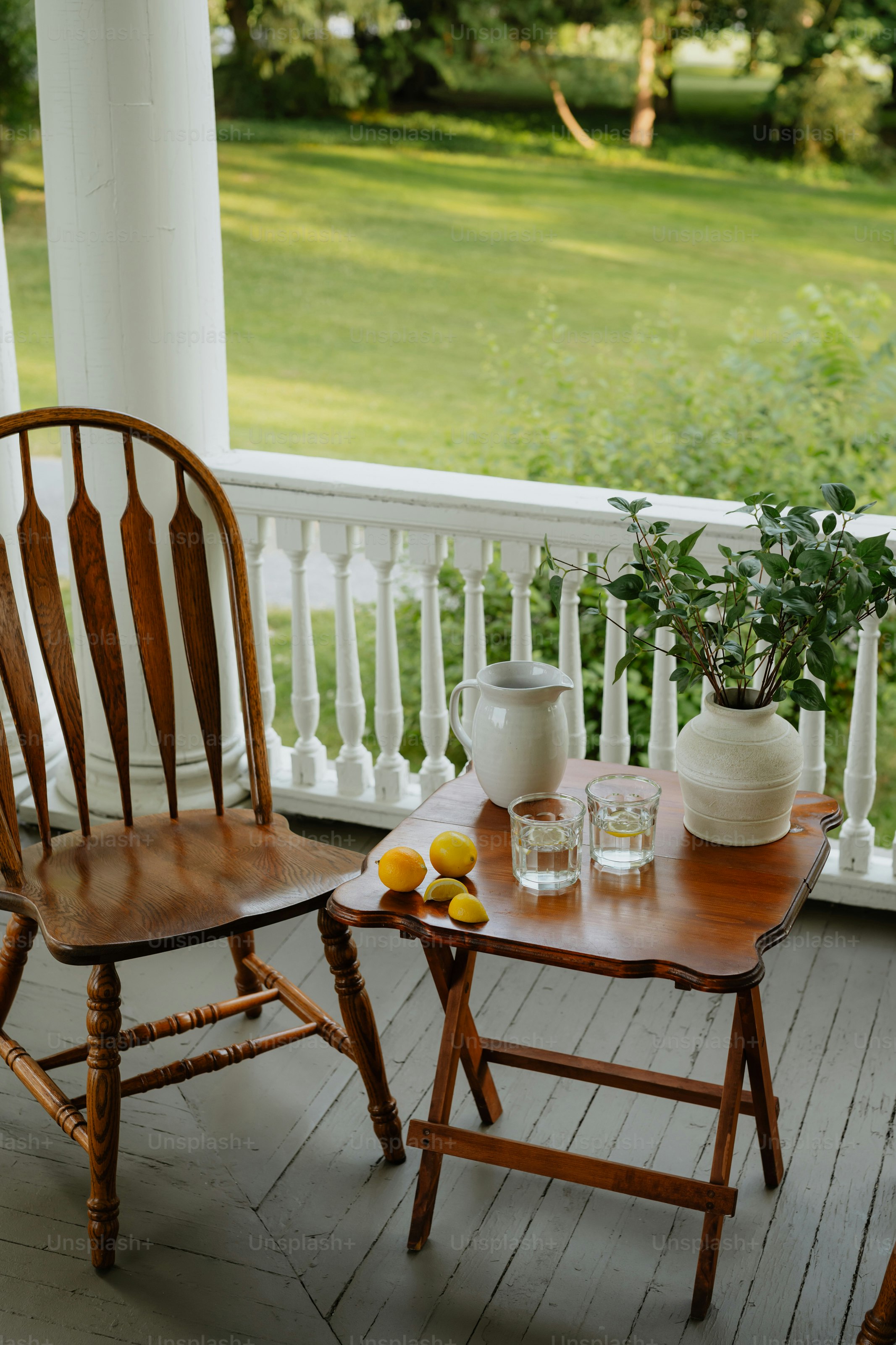Two chairs and a table on a porch