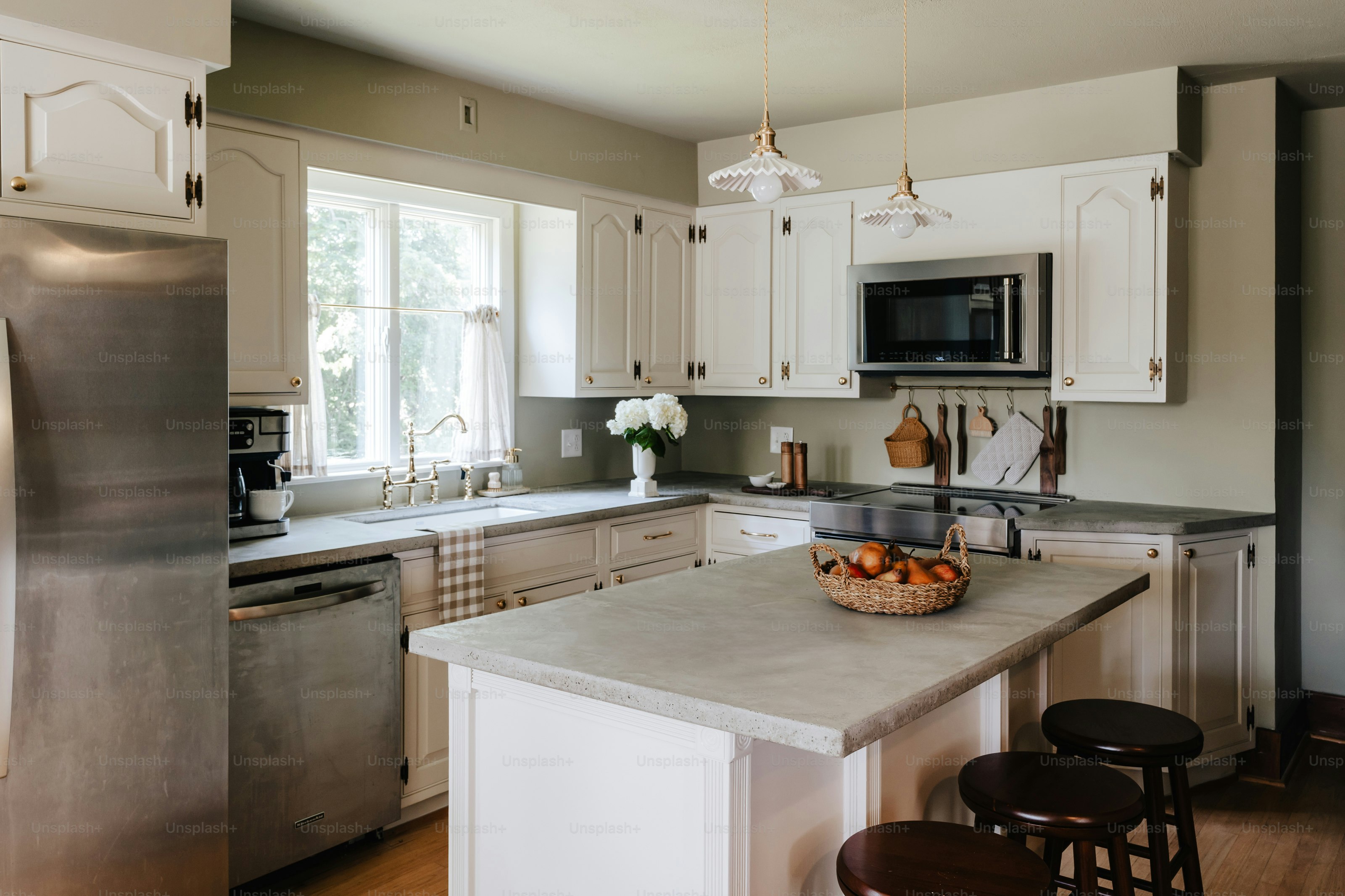 A kitchen with a center island and a microwave