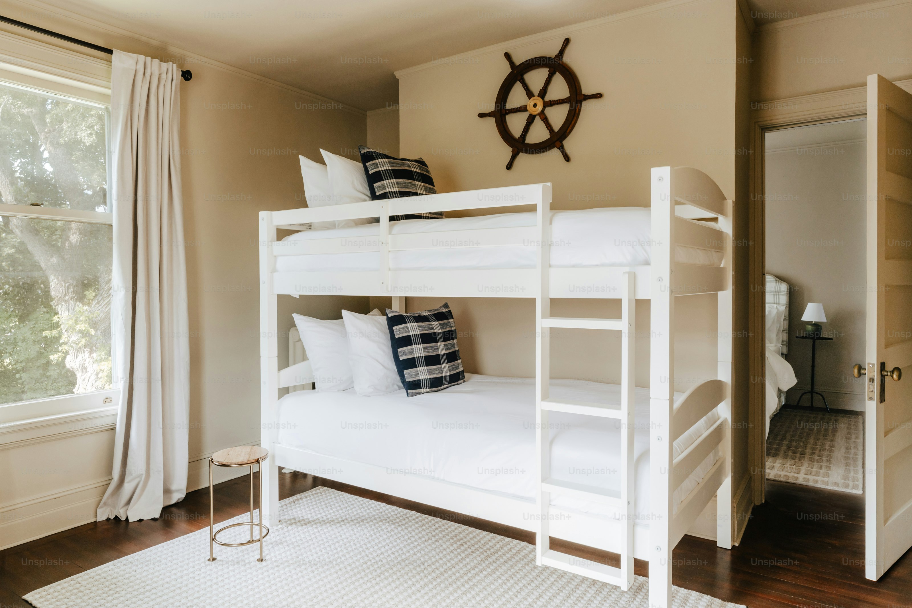 A bedroom with a bunk bed and a window