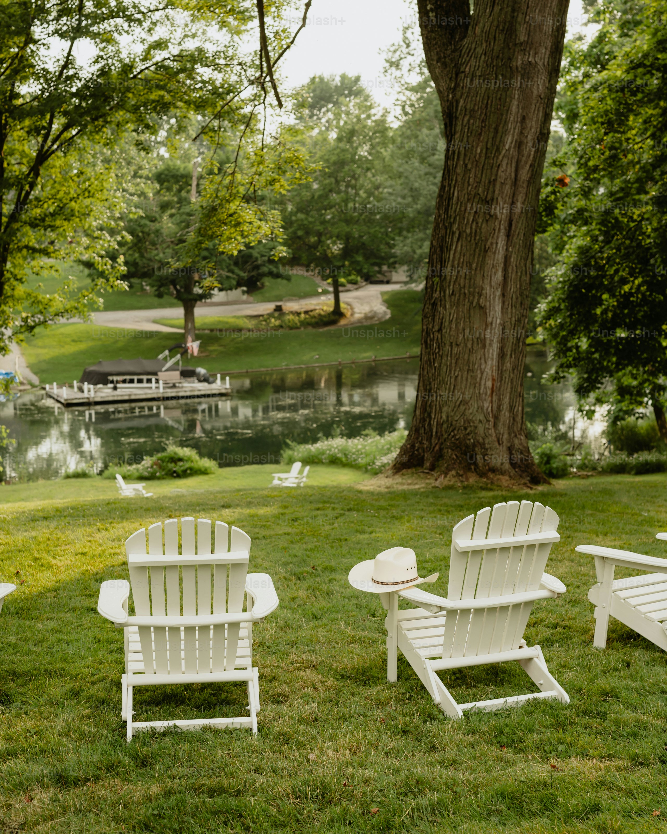 A group of lawn chairs sitting on top of a lush green field
