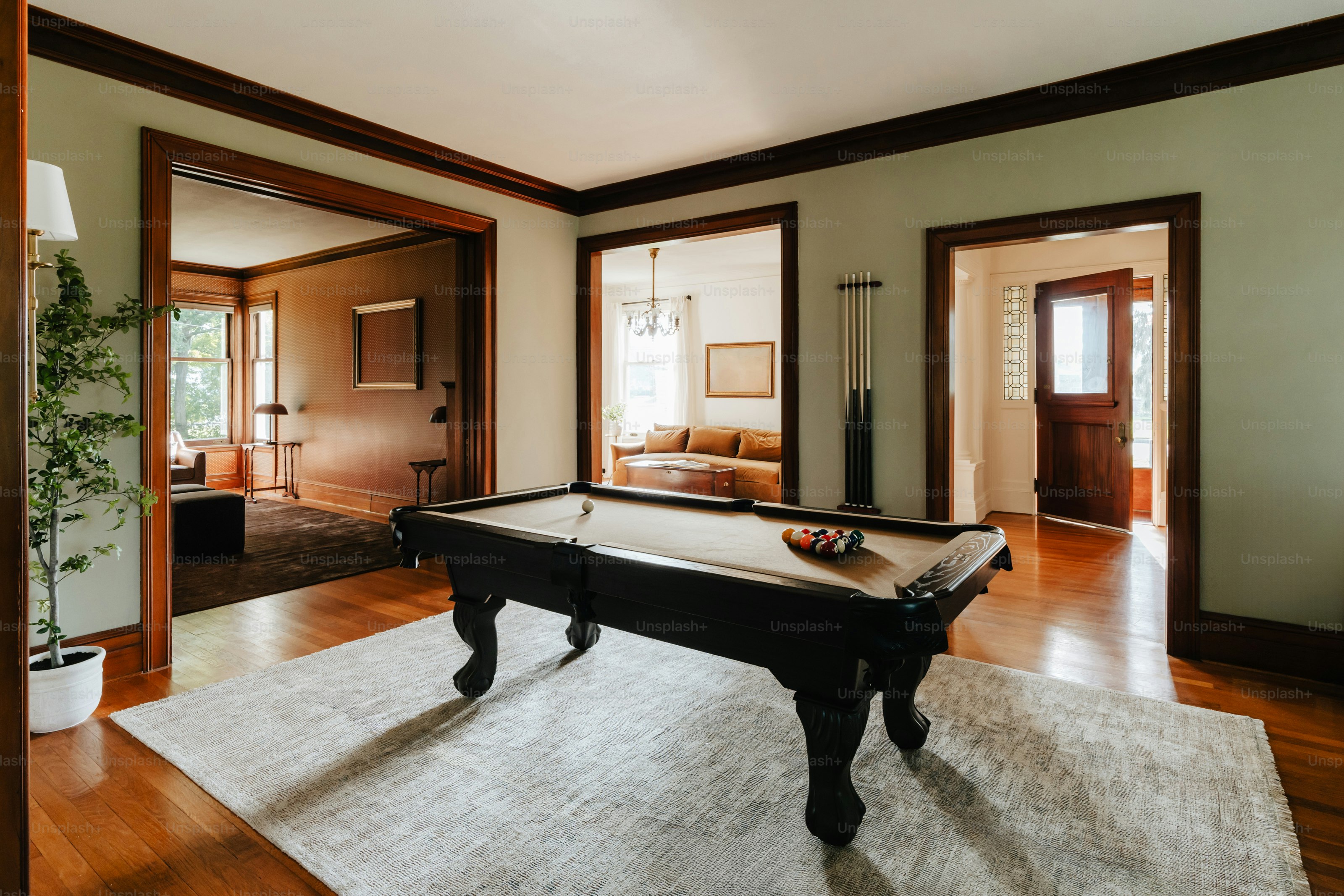 A living room with a pool table in it