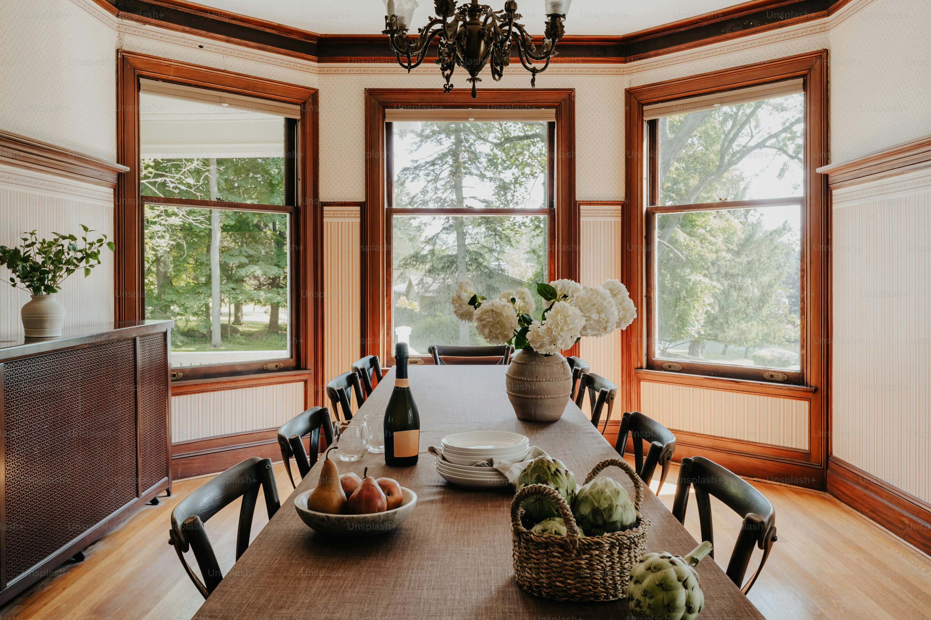 A dining room with a table and a TV
