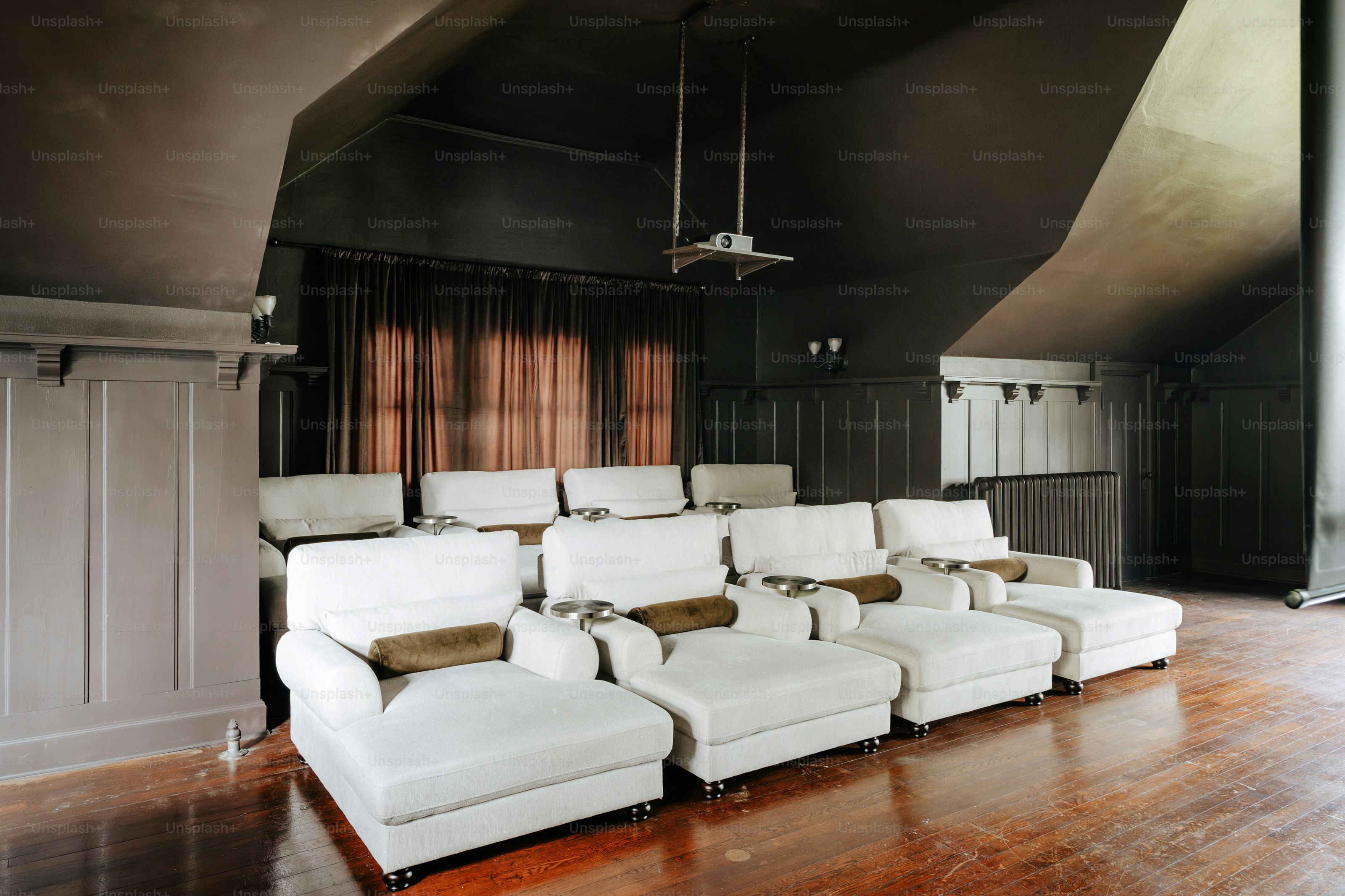 A room with a lot of white couches in it