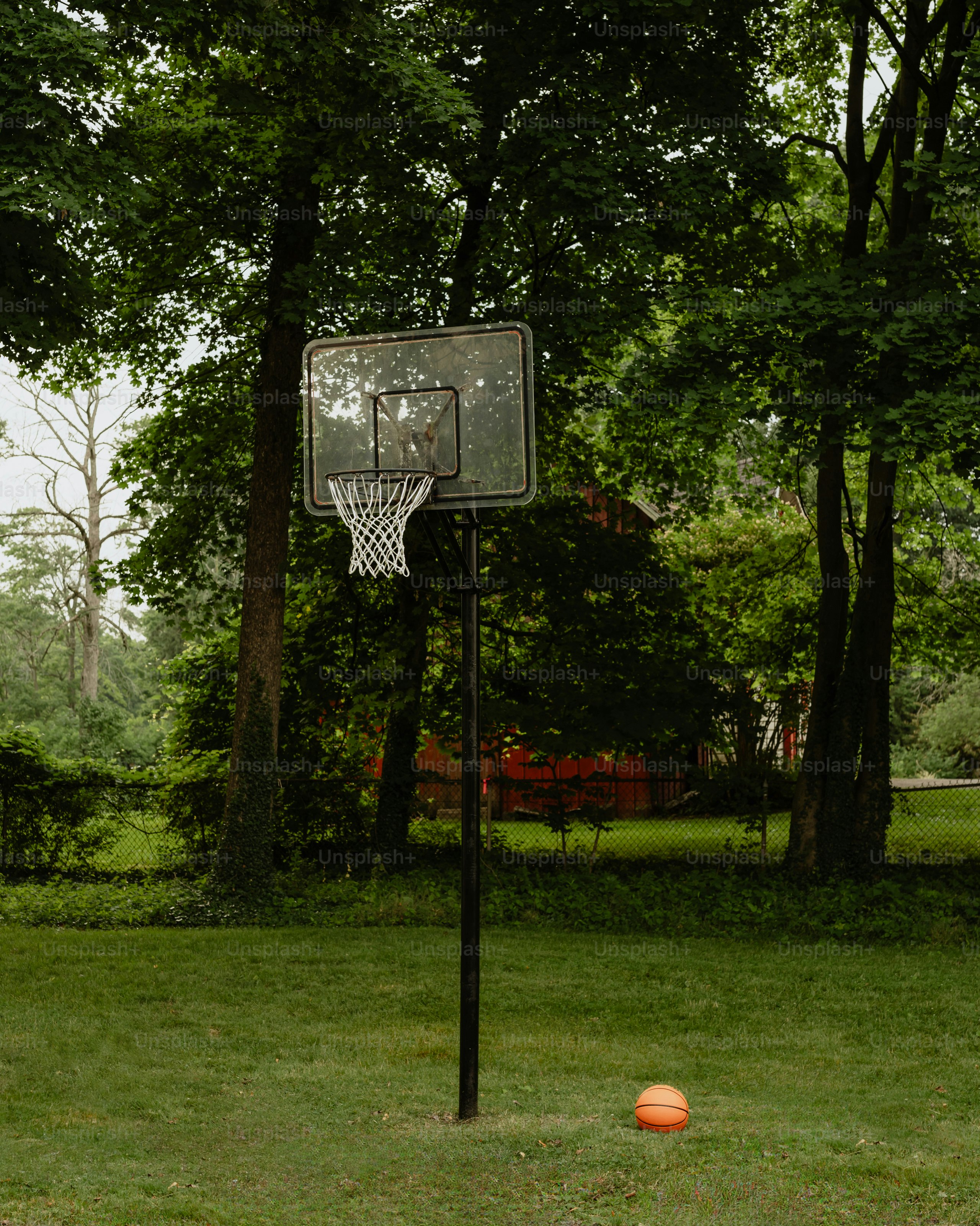 A basketball is in the air near a basketball hoop