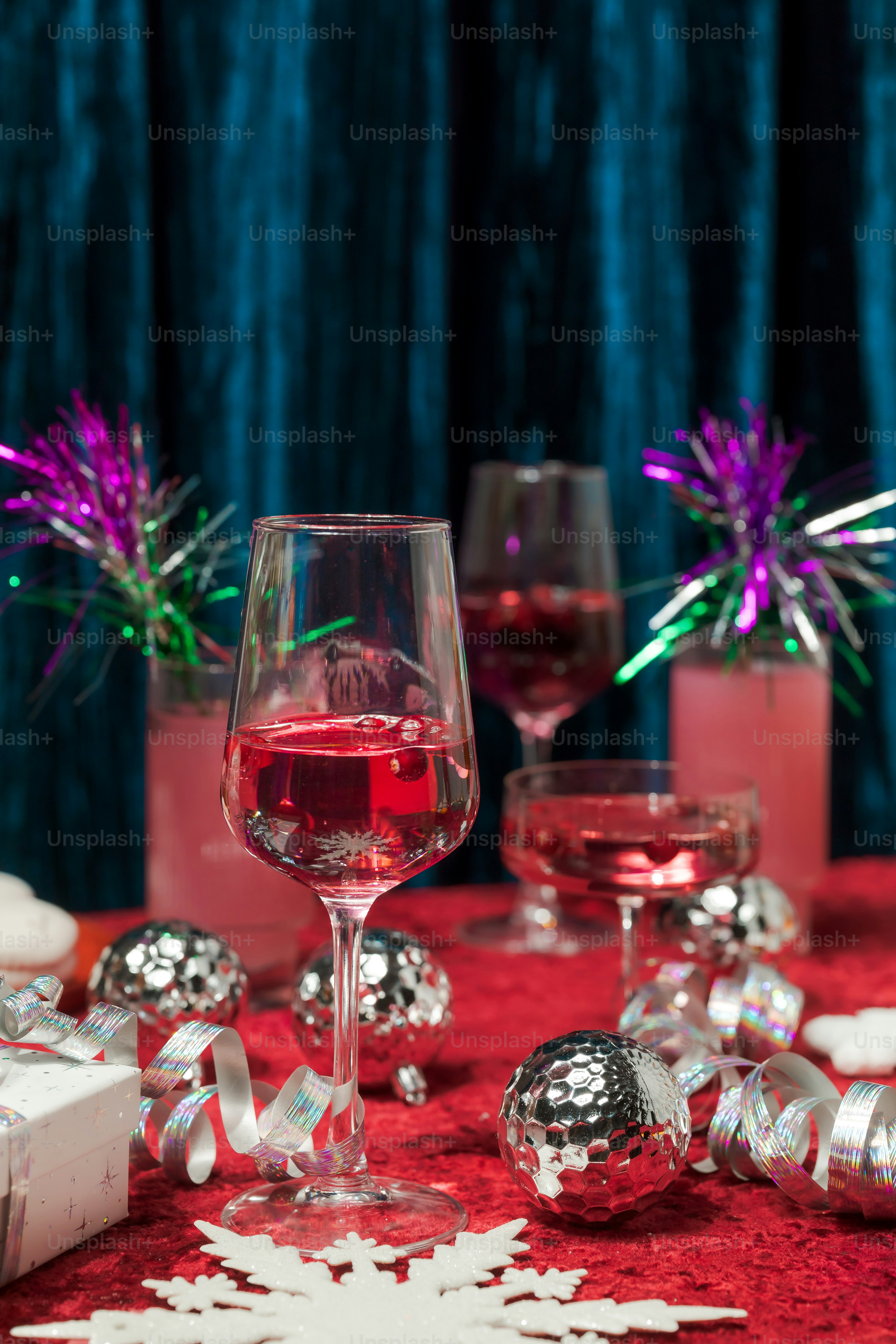 A table topped with wine glasses filled with red wine photo  Christmas  Image on Unsplash