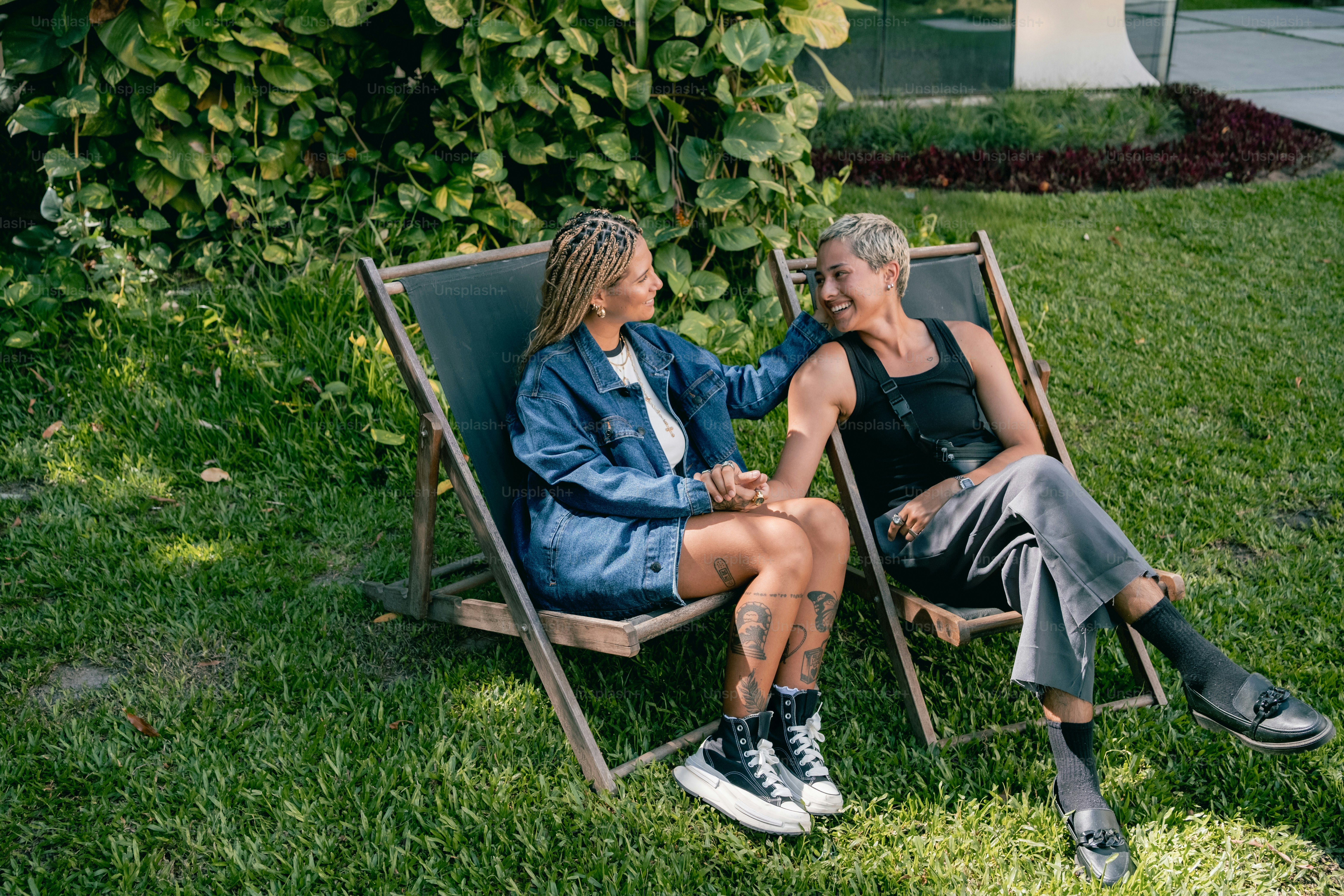 A couple of people sitting on top of lawn chairs