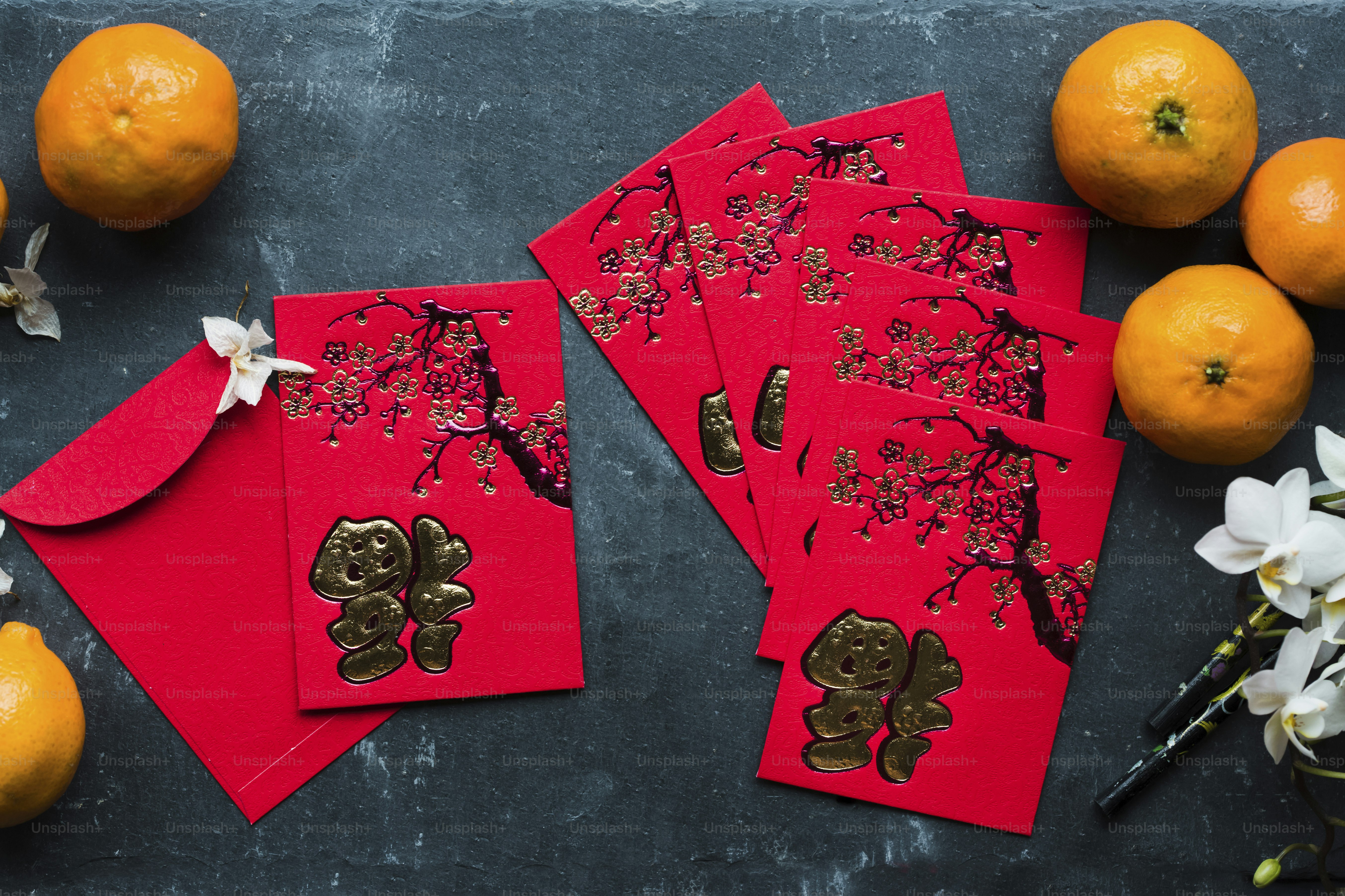 A red table topped with cards and oranges photo – Lunar new year Image ...