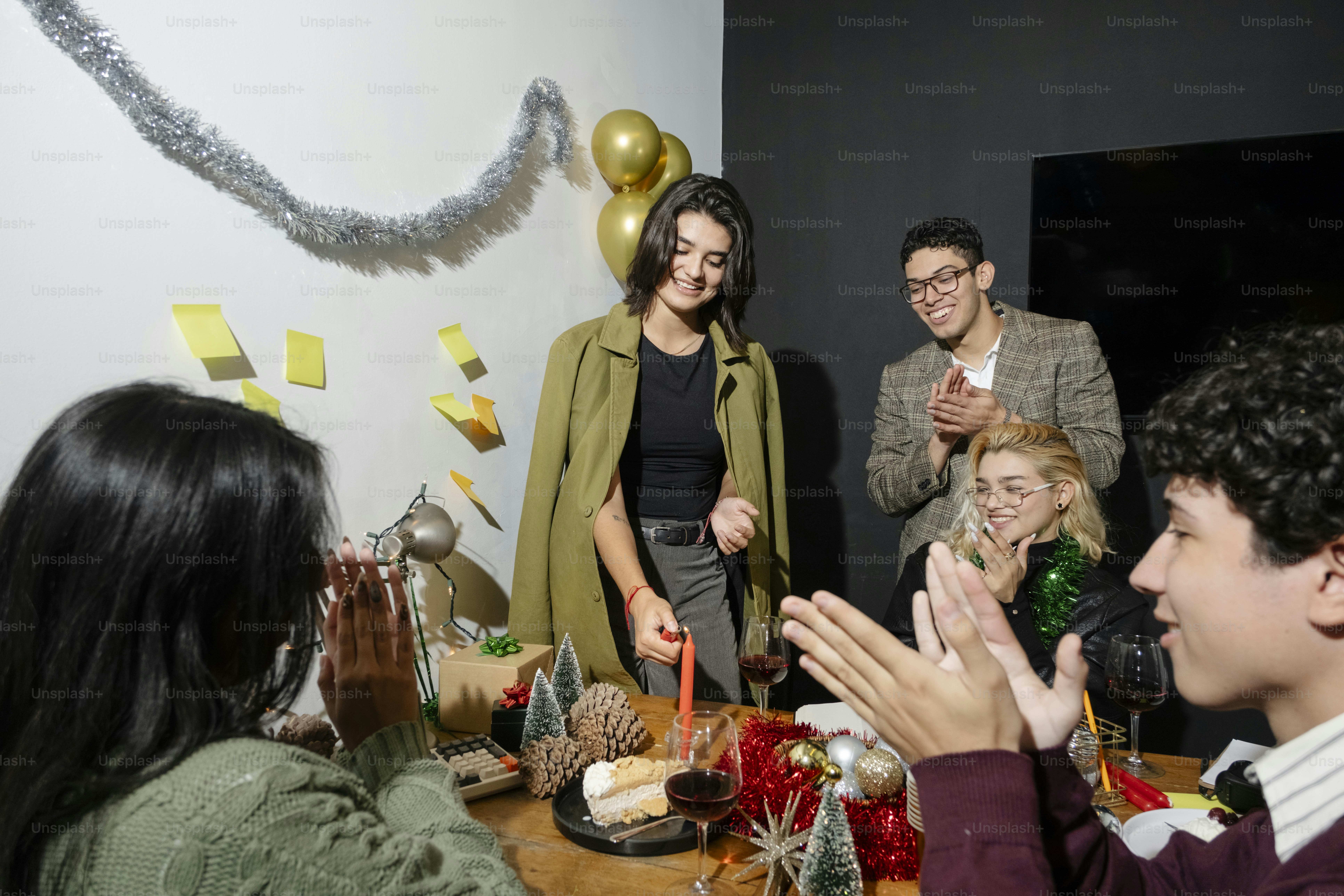 A group of people standing around a table photo – Christmas Image on ...