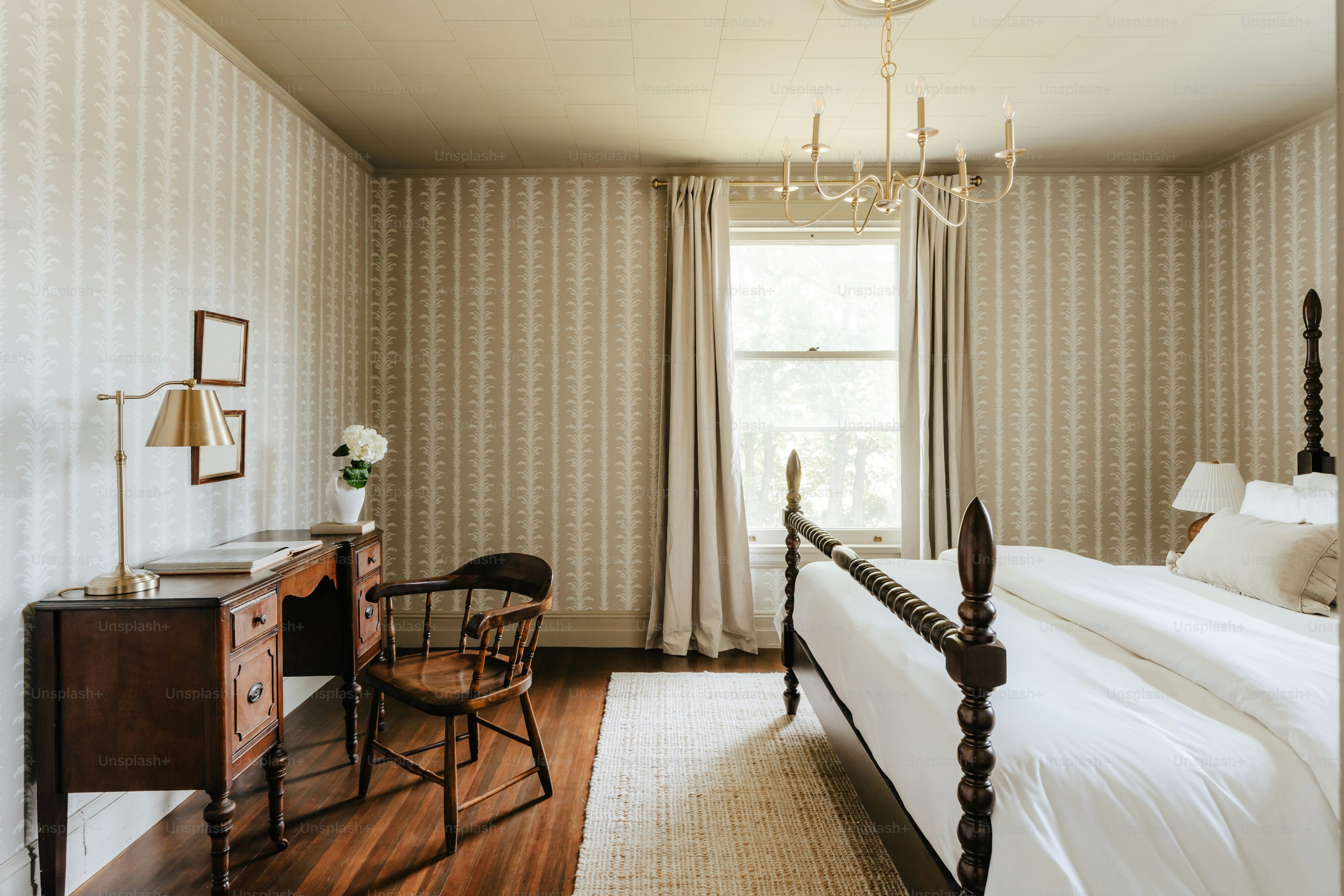 A bedroom with a large bed and a chair
