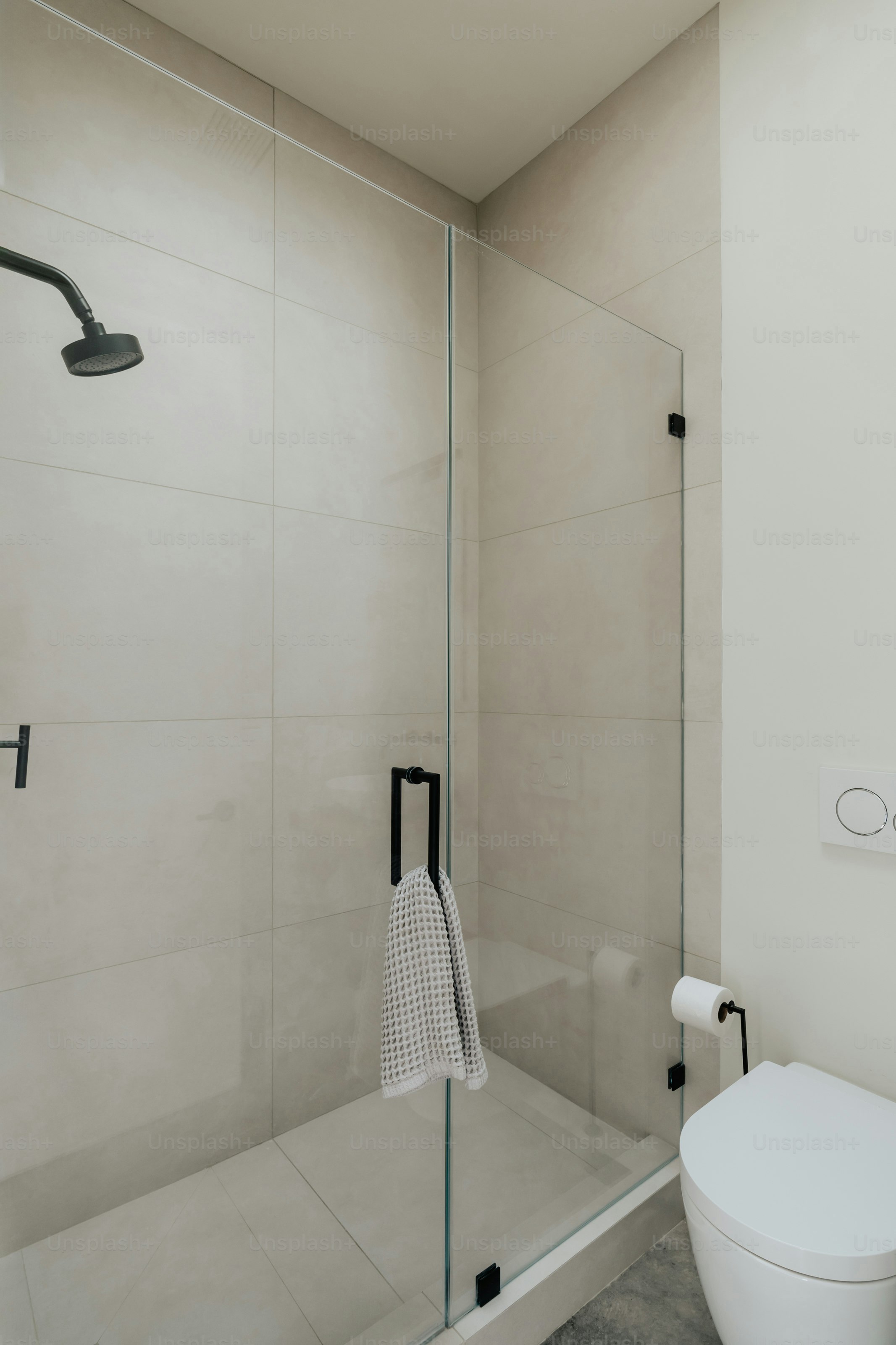 A white toilet sitting next to a walk in shower