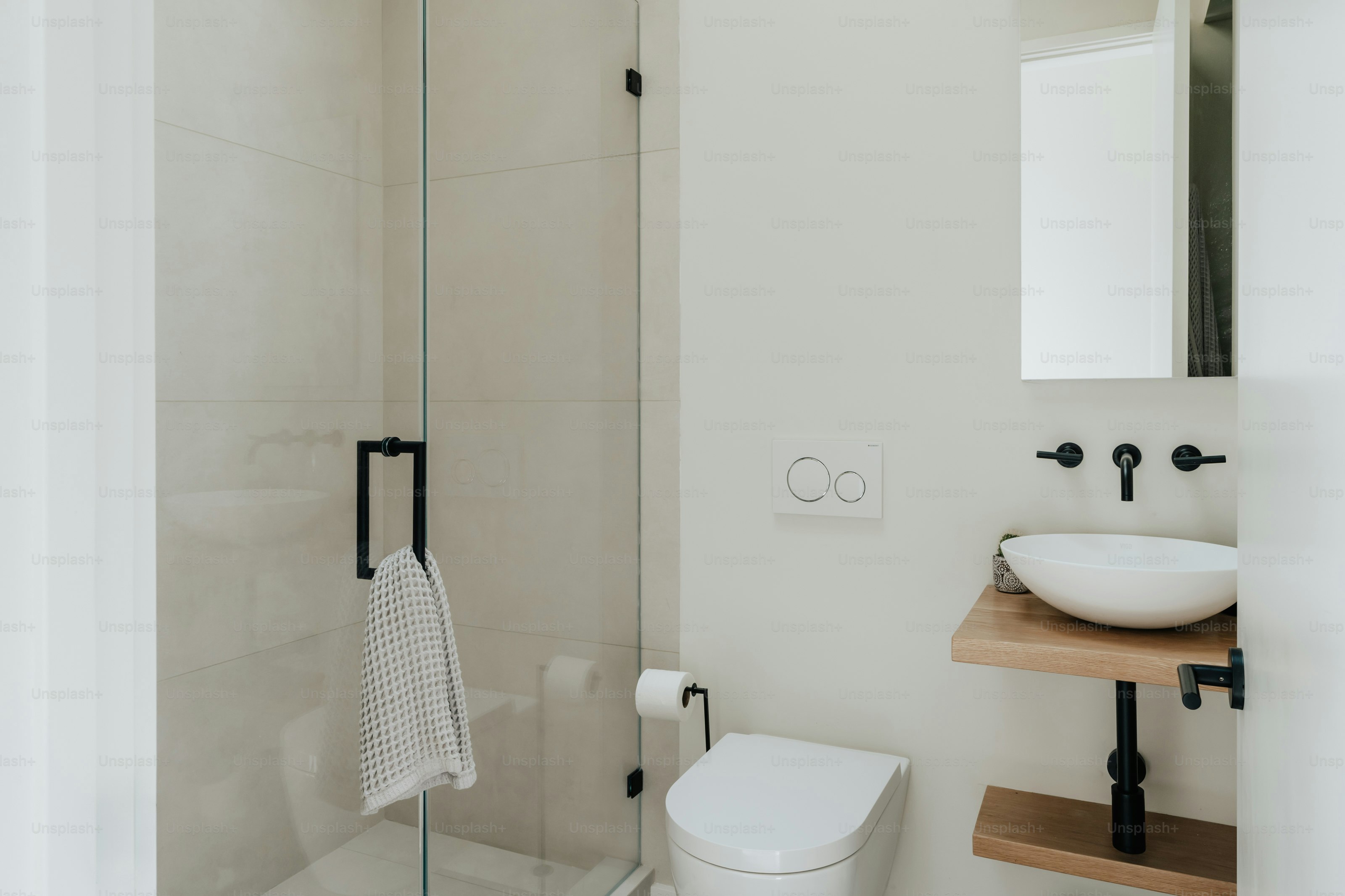 A bathroom with a toilet, sink, and shower