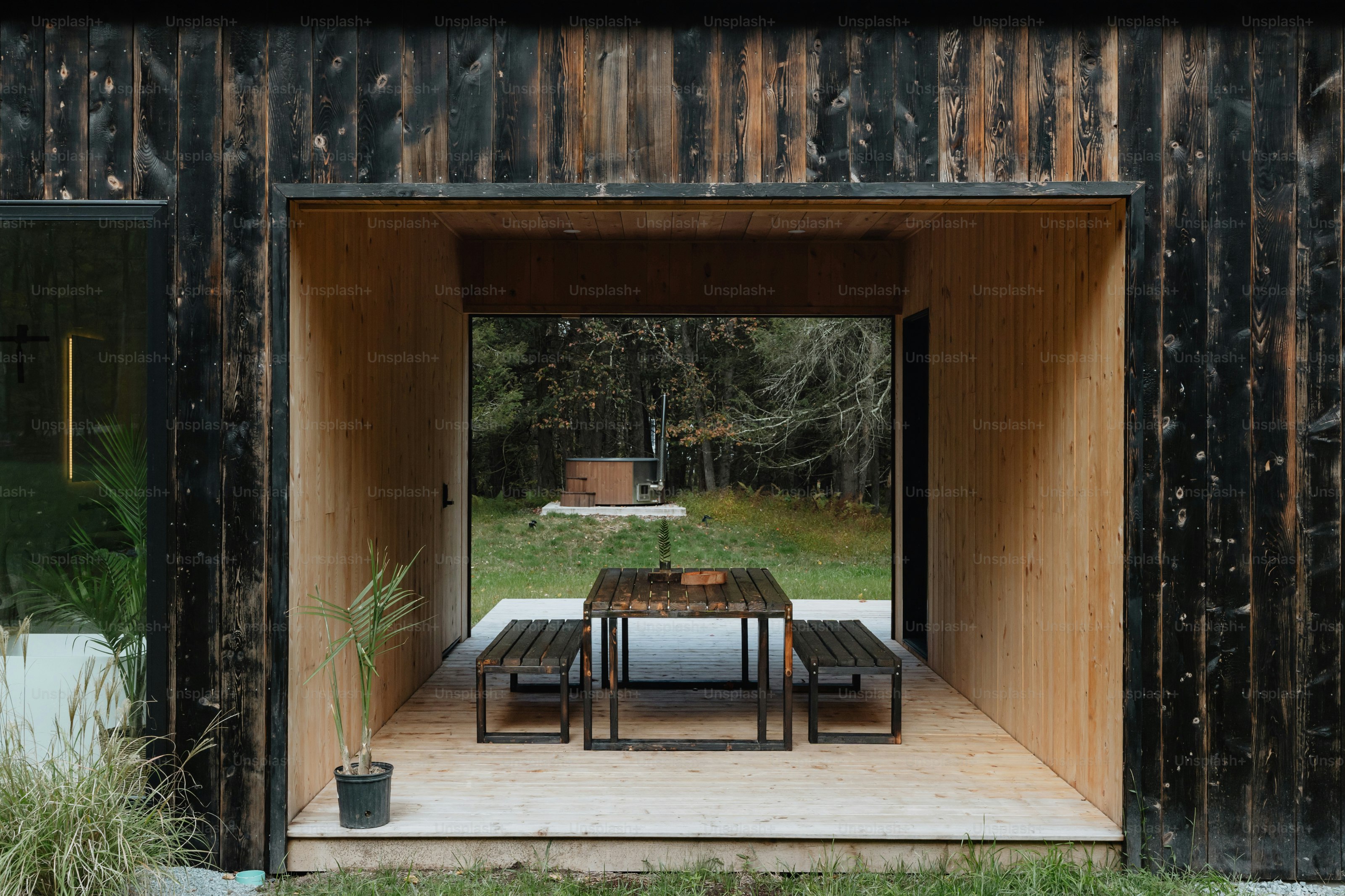 A wooden structure with a table and chairs in it