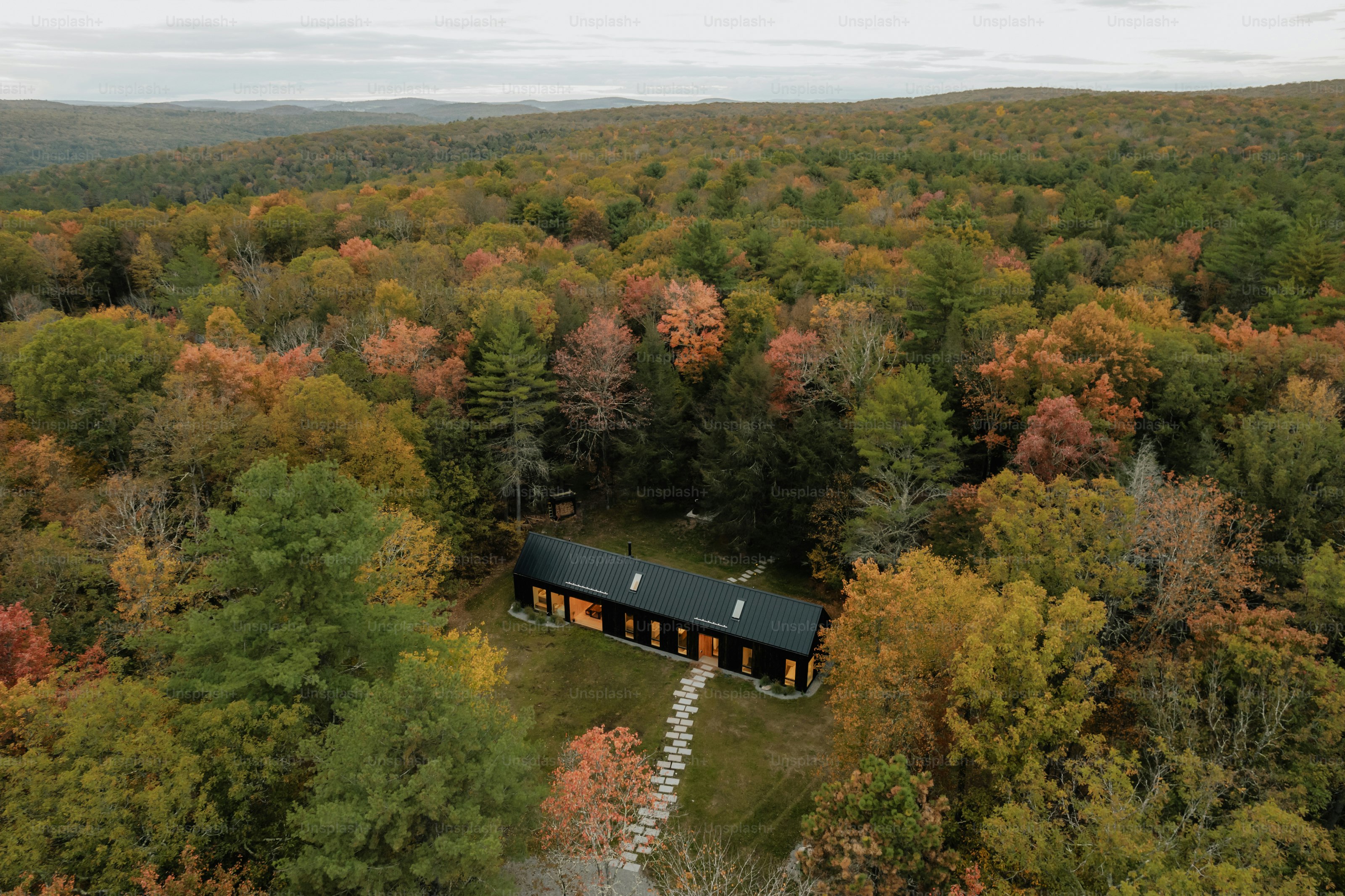 An aerial view of a cabin in the woods