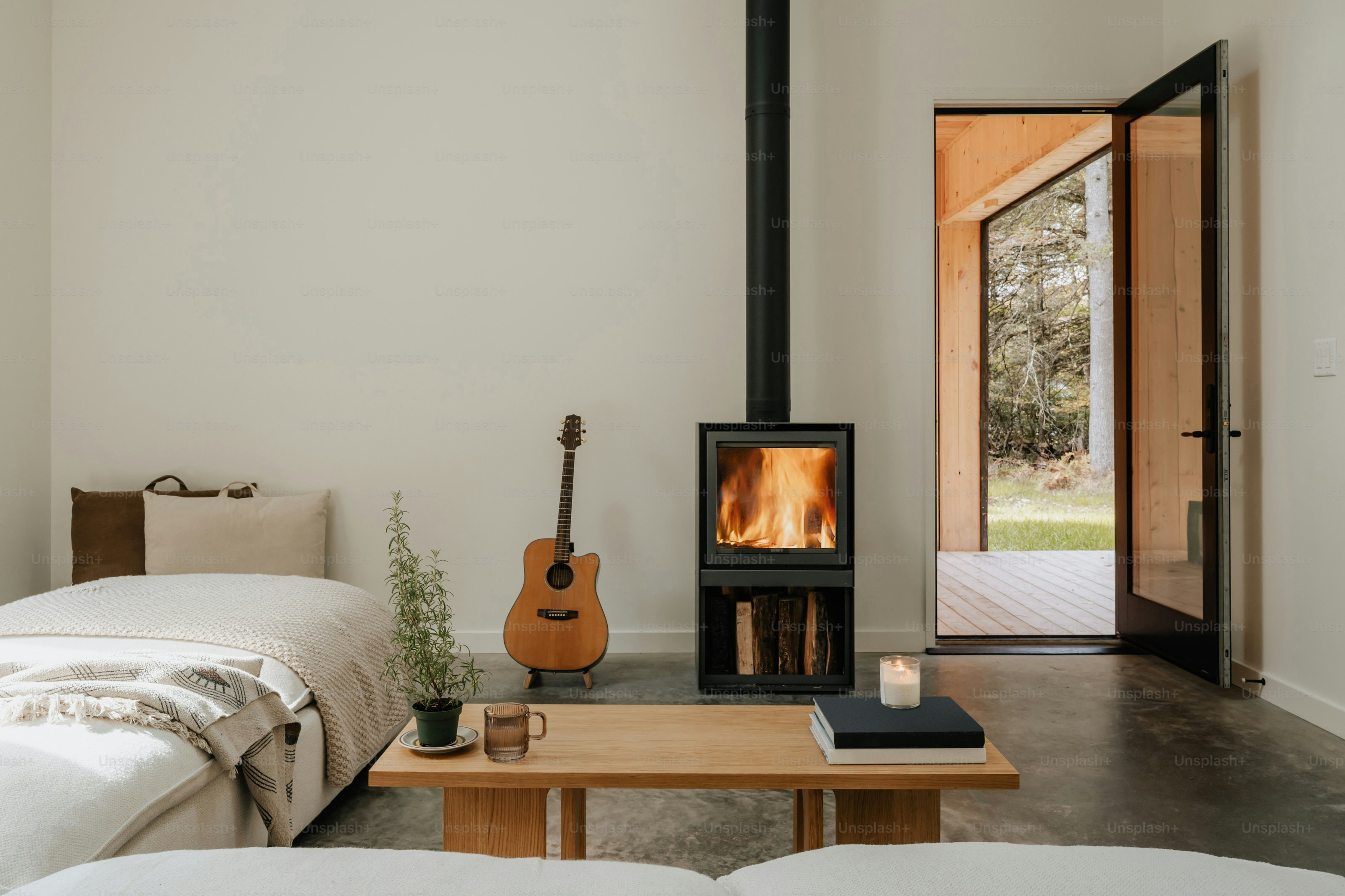 A room with a bed, a table, and a fireplace