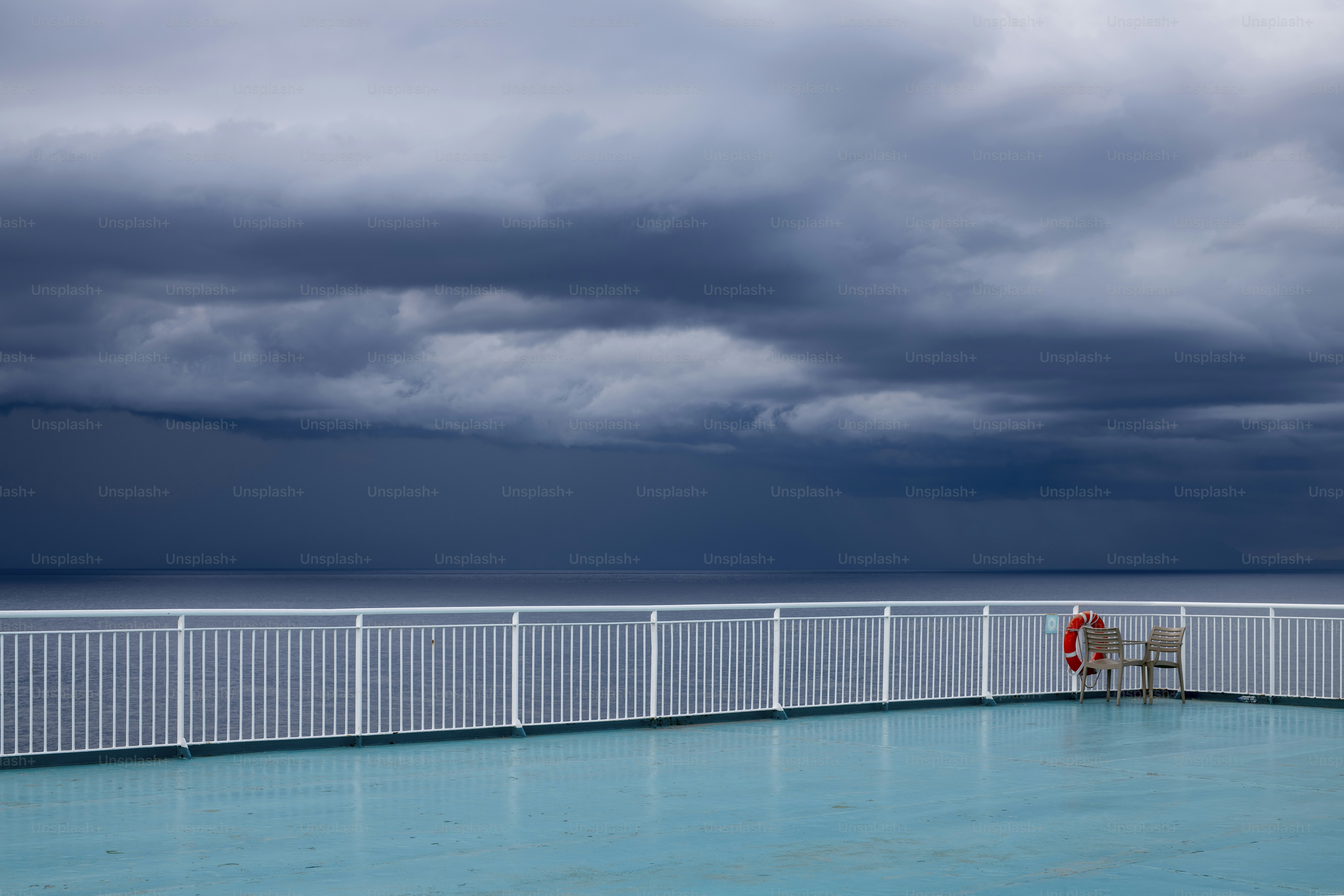 A large swimming pool with a white fence around it