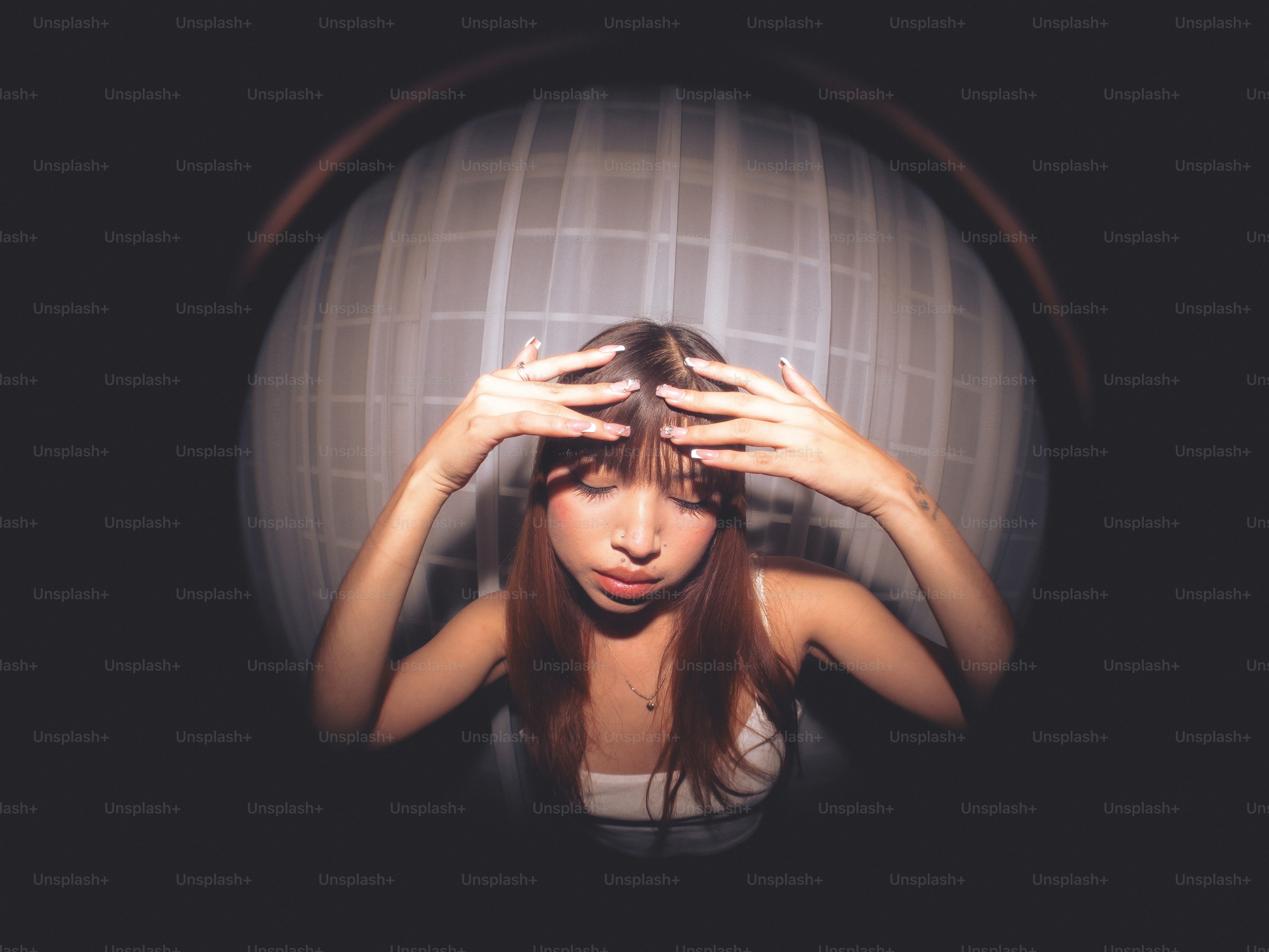 A woman covering her eyes with her hands