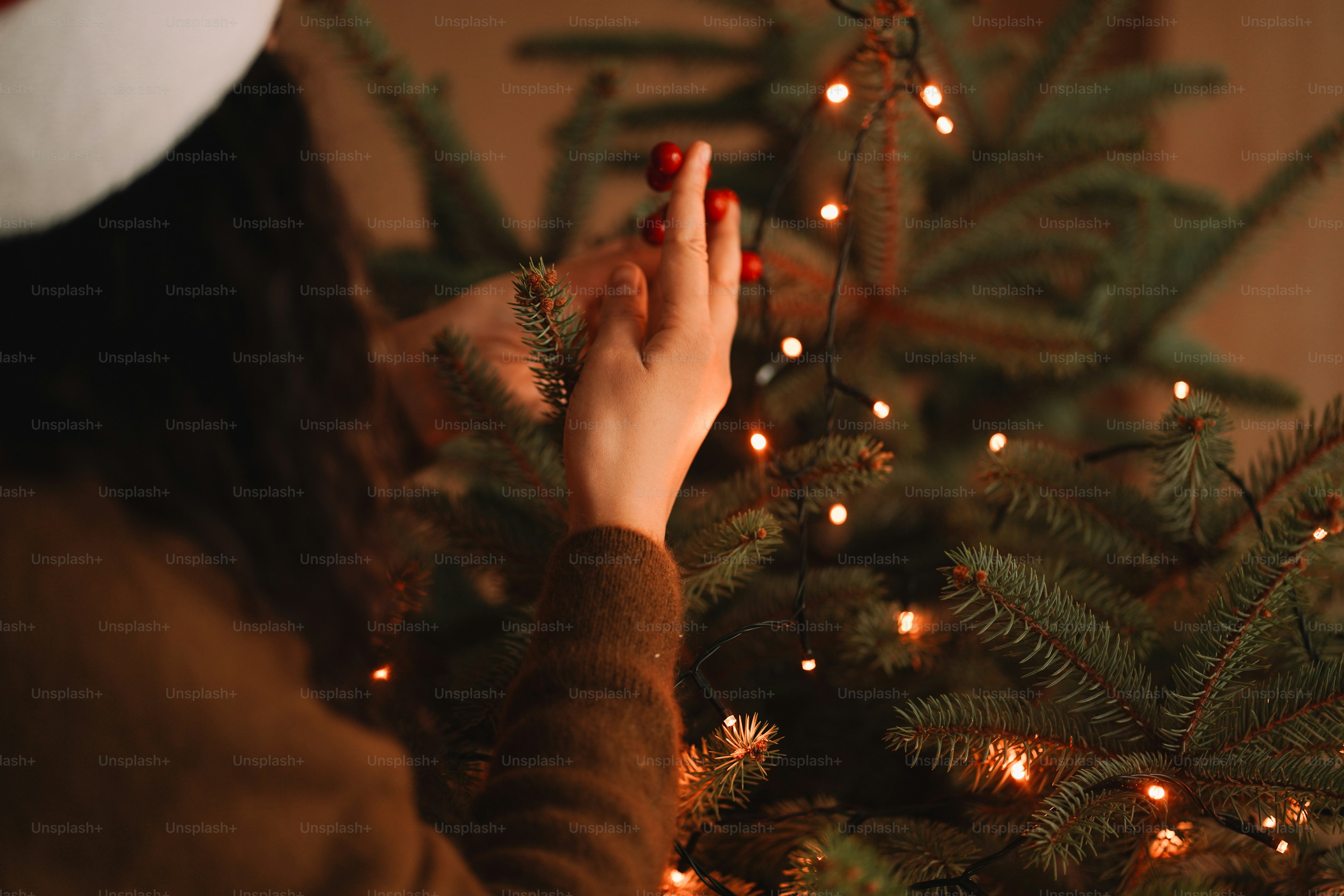 A woman standing in front of a christmas tree