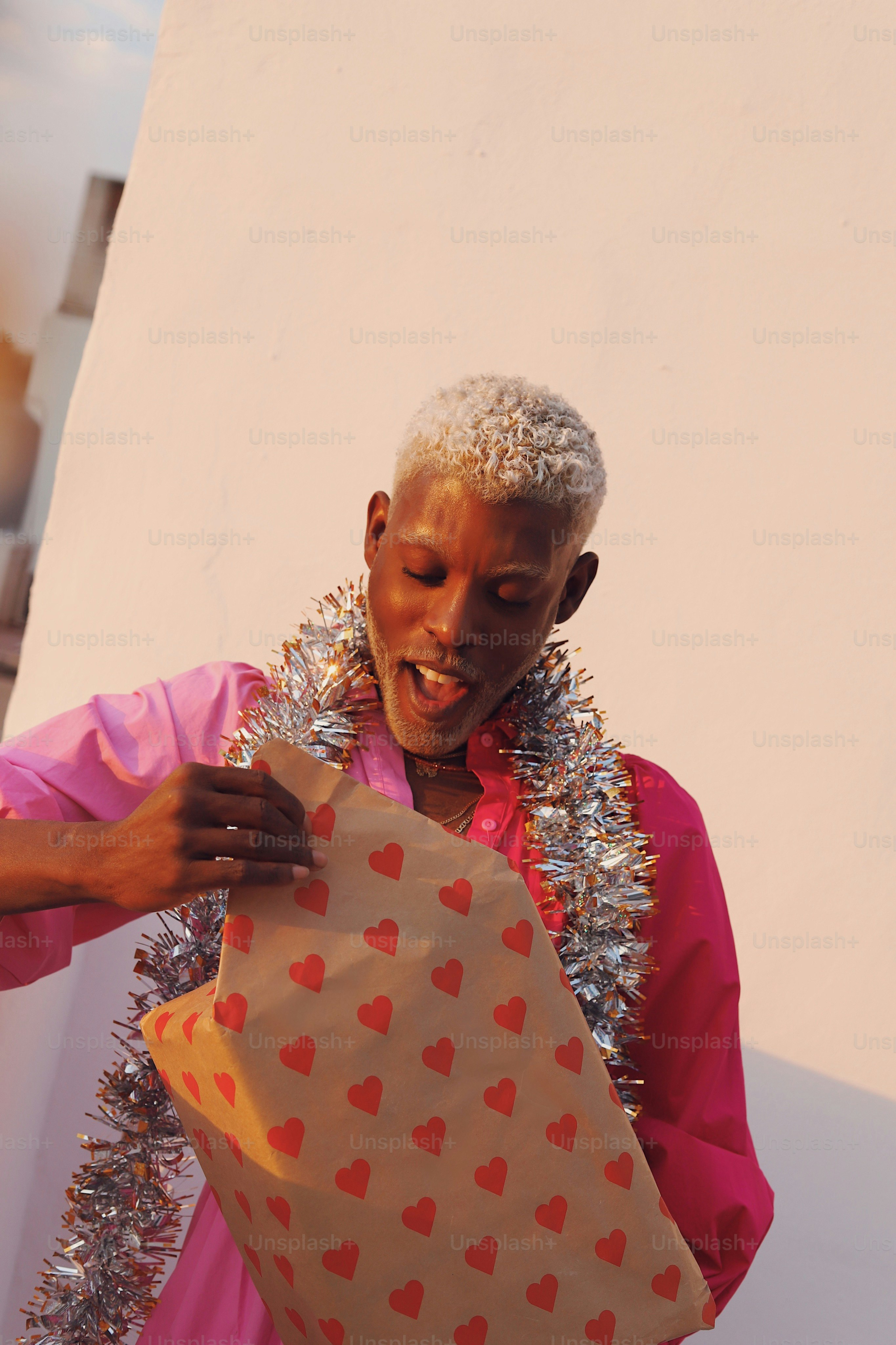 A man holding a bag with hearts on it